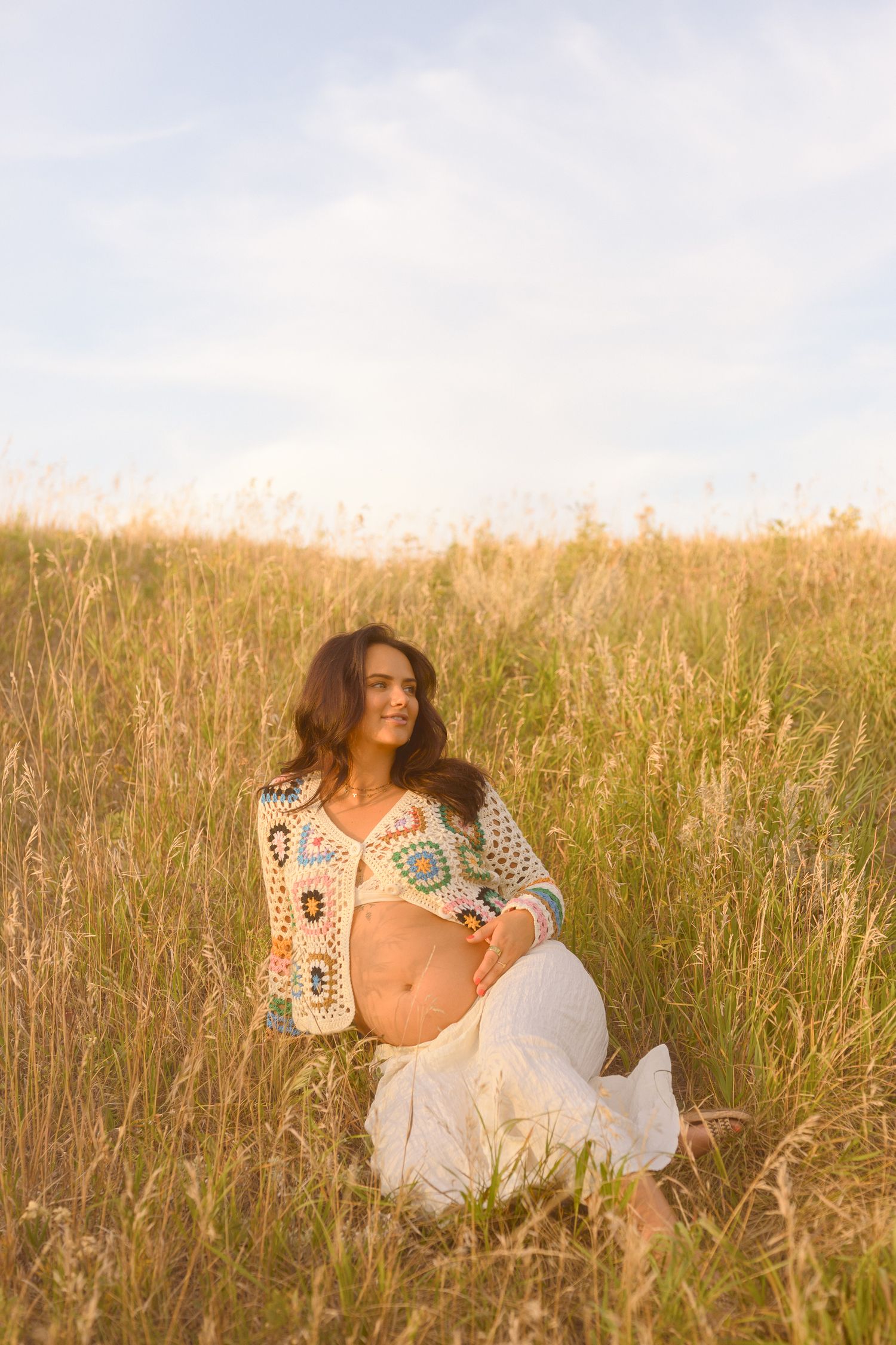 Dreamy summer photography in a wild grass field with soft natural lighting.
