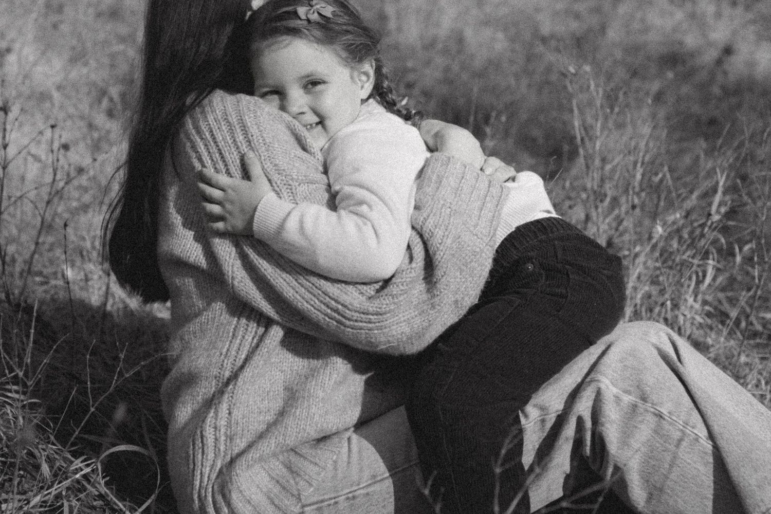 A series of vintage black and white photographs showing children playing and interacting outdoors in a rural setting.