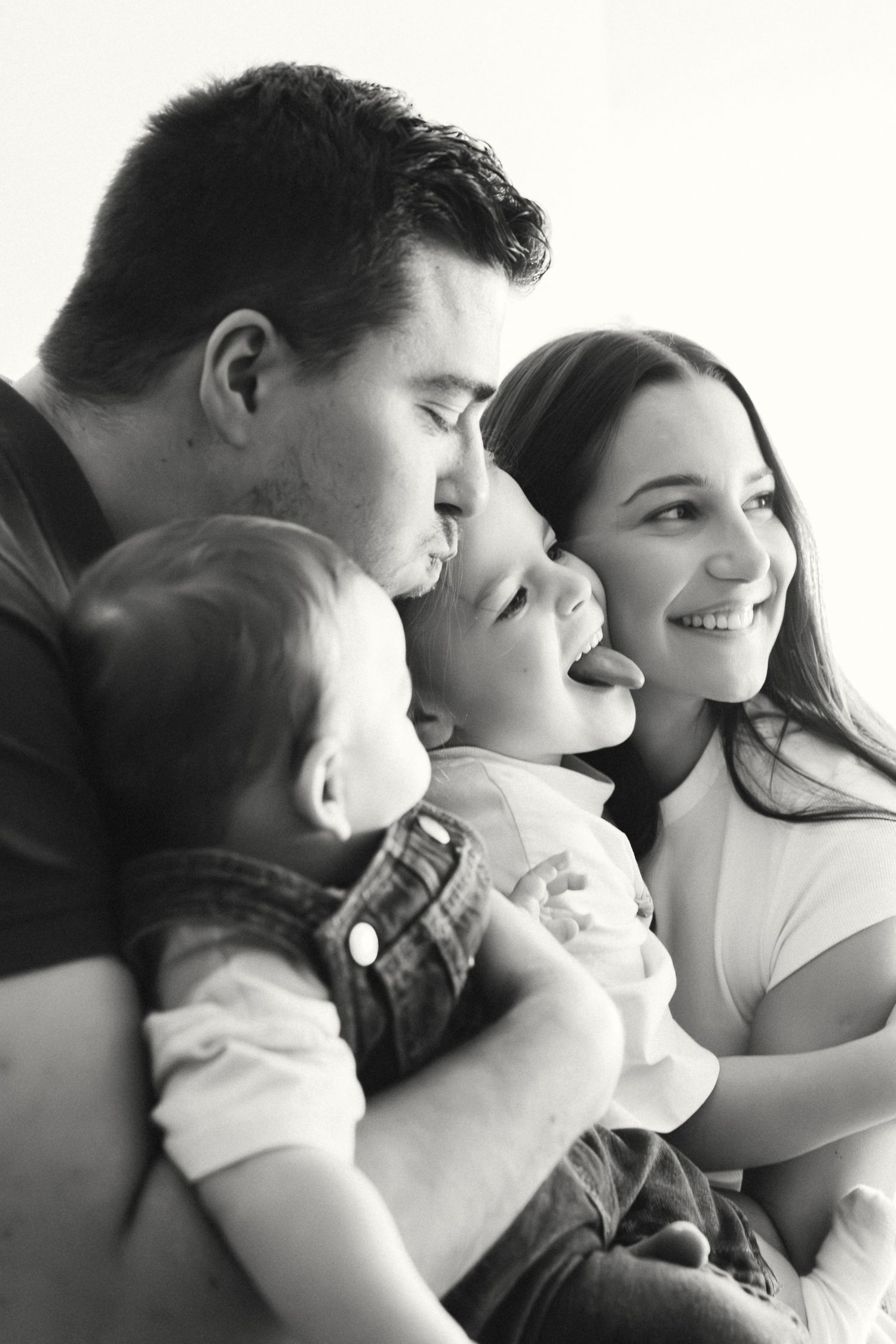 A series of intimate black and white photographs showing tender moments between a couple in close embrace.