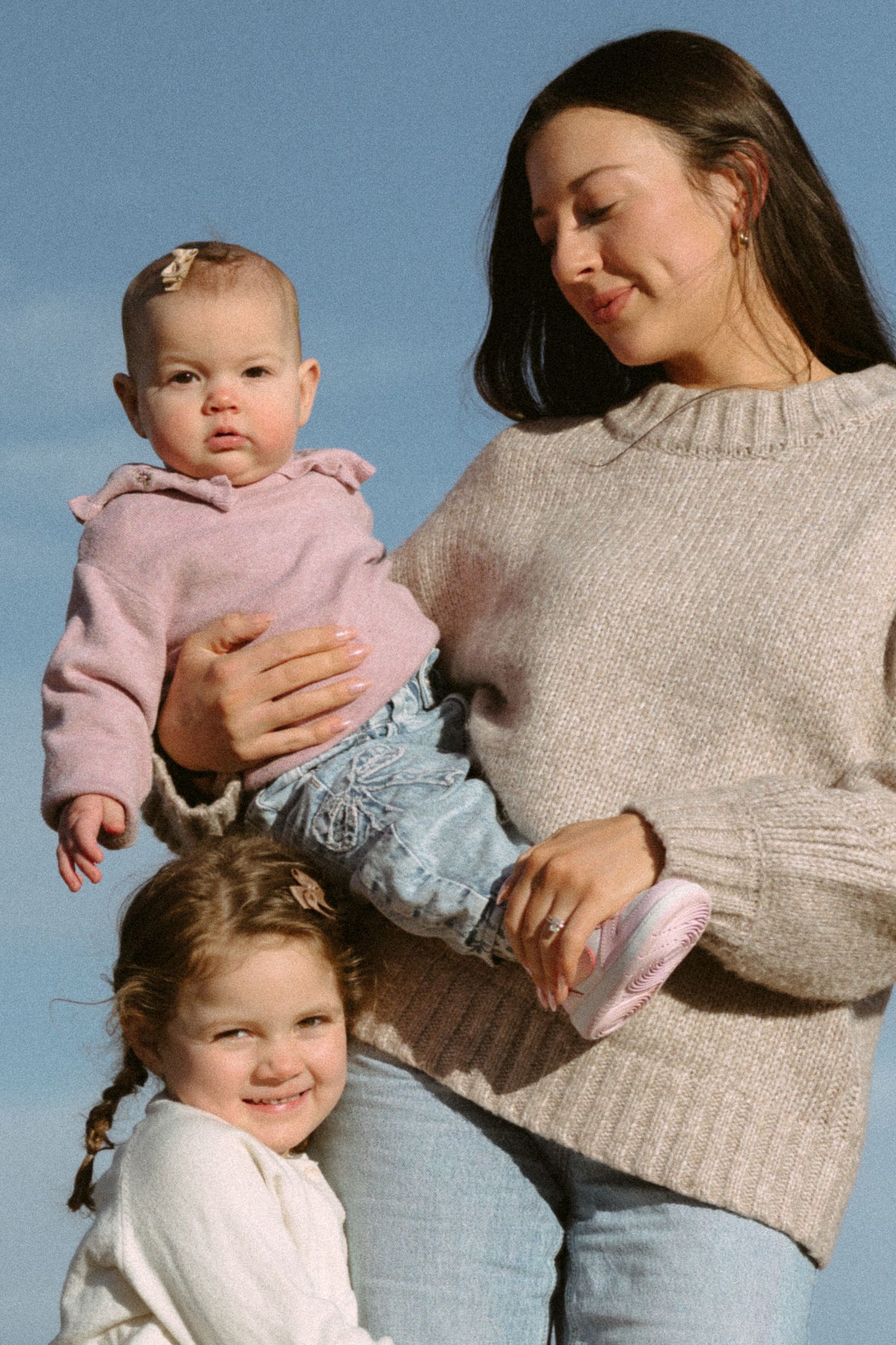 A heartwarming sequence of family photos showing playful interaction between parent and children against a blue sky background.