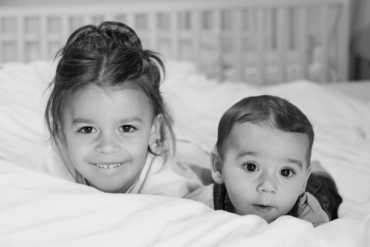 A series of five black and white headshots showing a young child in different expressions.