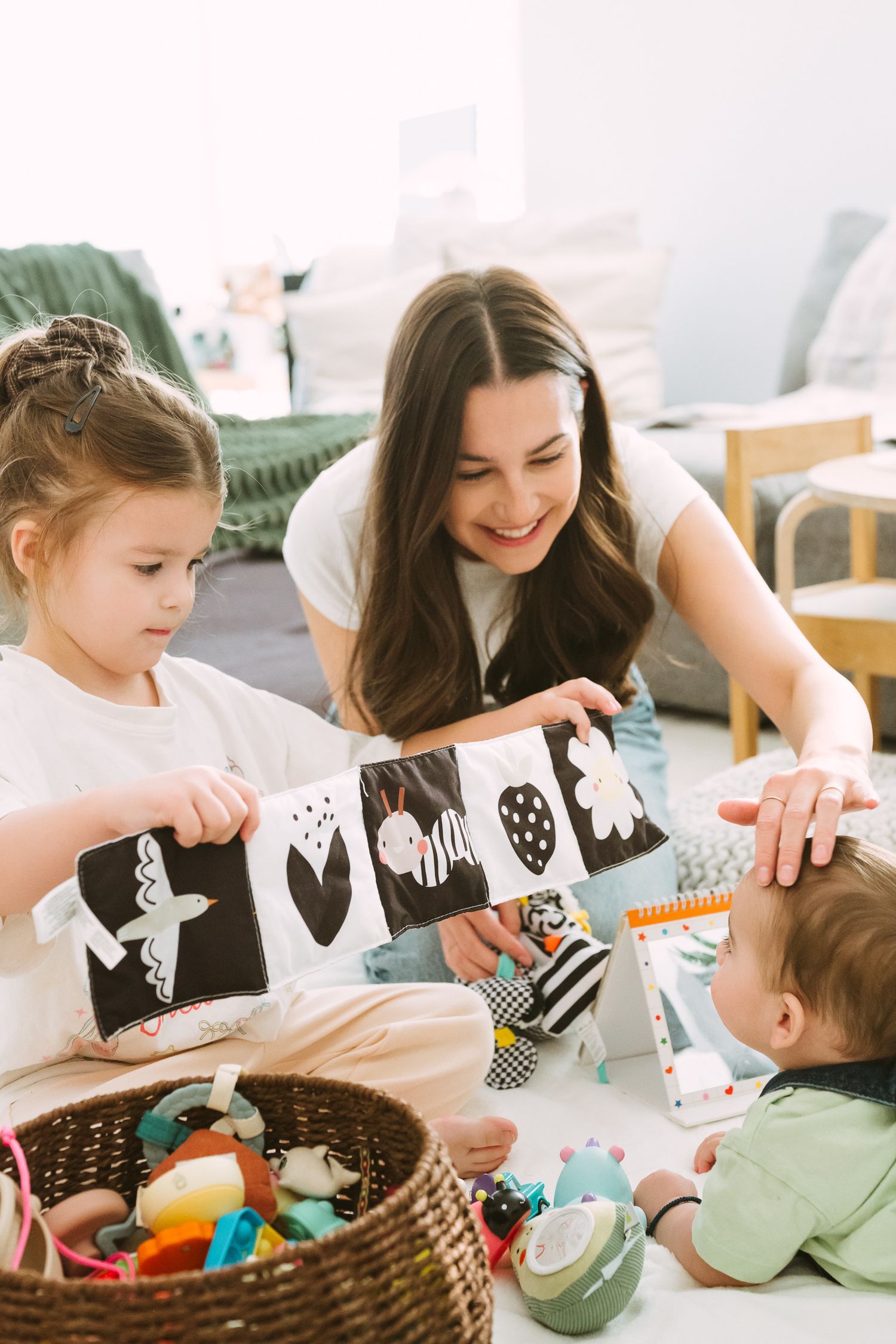 Children and adults gather around a table to decorate Easter eggs with crafting supplies and colorful decorations.