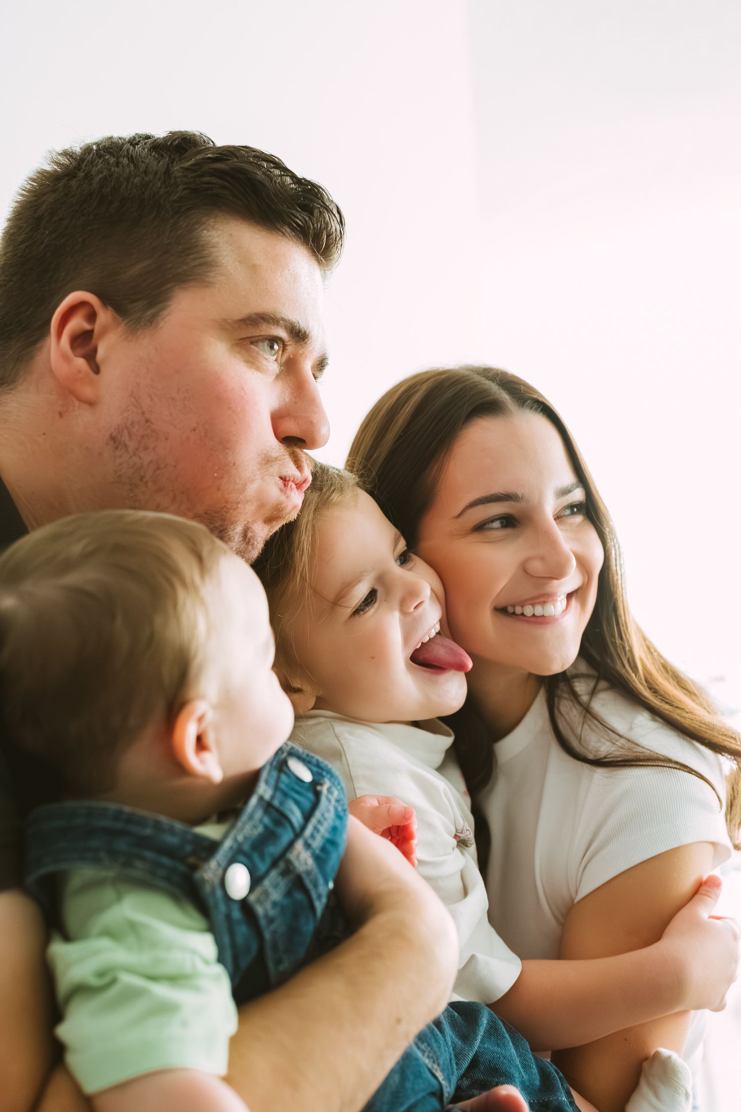 A series of five connected photos showing a loving family moment with parents and child laughing together.