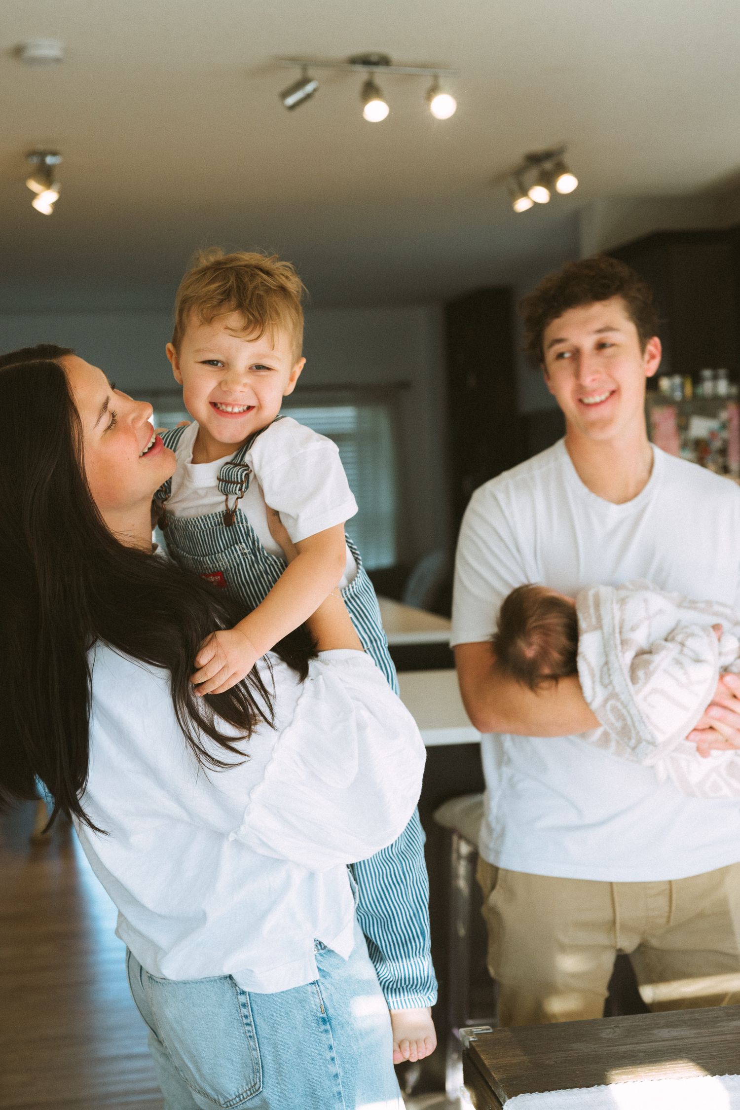 Series of candid family moments captured in natural light showing playful interactions in a modern home setting.