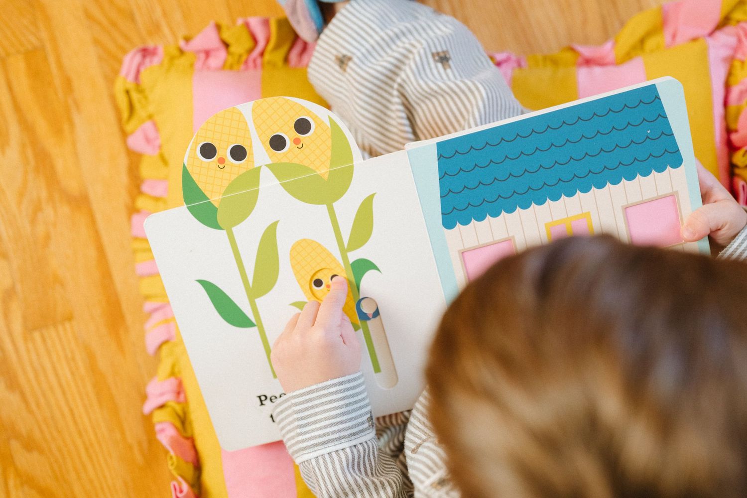 Colorful nursery scene with pink and yellow decor elements.