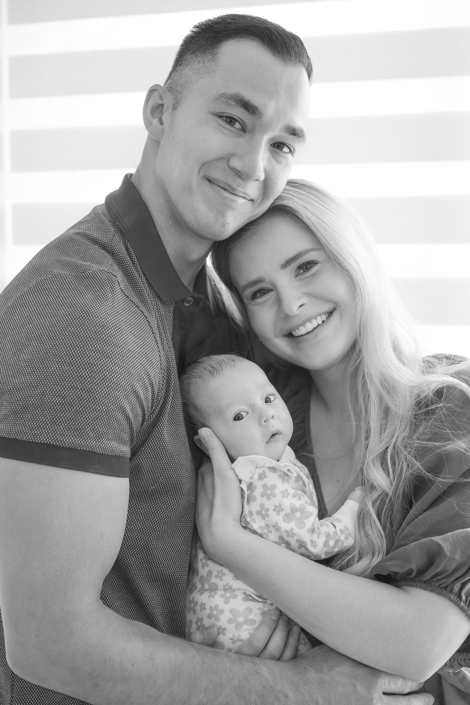 Family portrait series showing joyful moments between parents and their newborn.