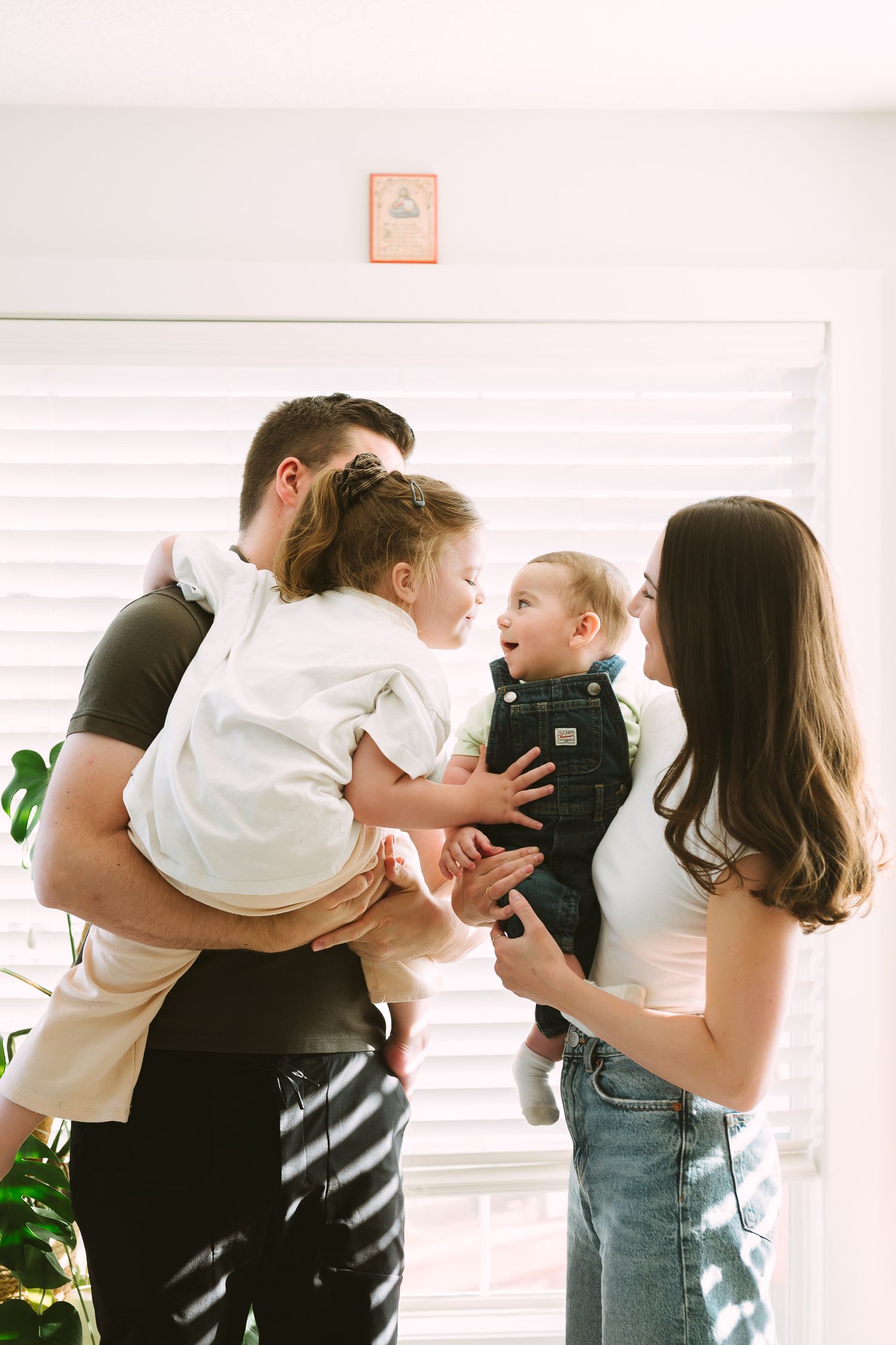 A sequence of candid family photos showing playful interactions and tender moments in a bright interior setting.