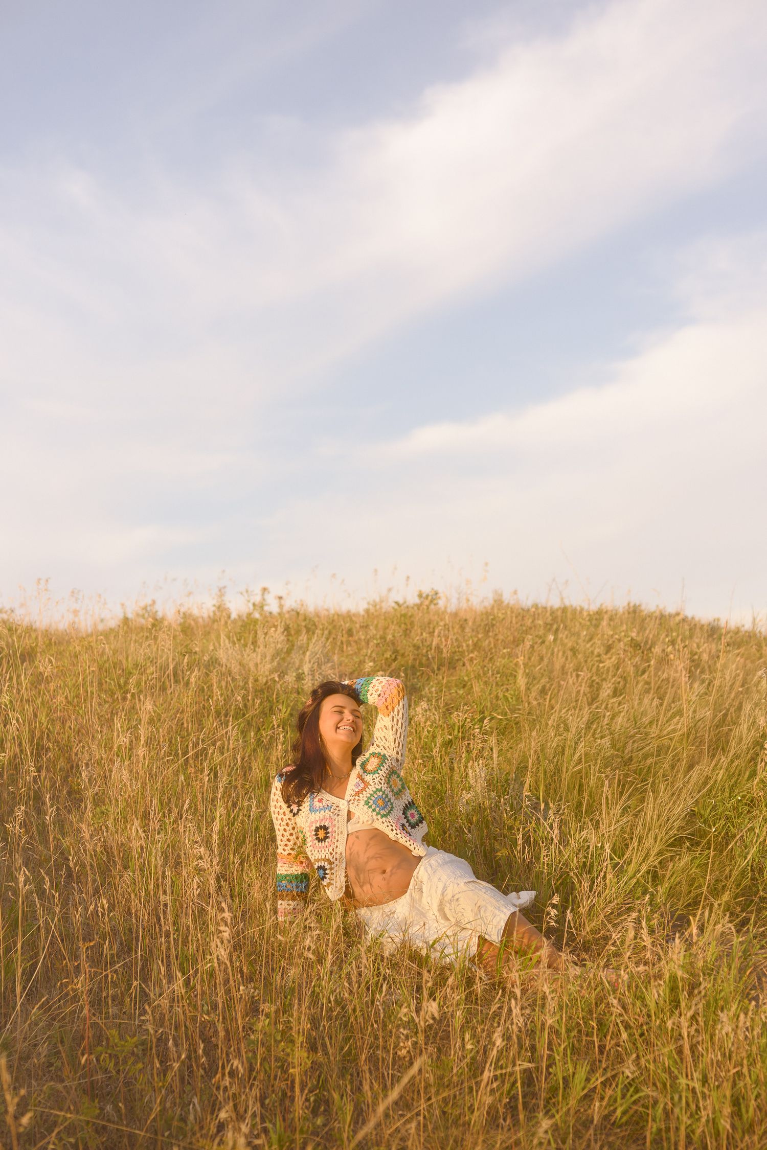 Artistic lifestyle photography in a rustic field during golden hour.