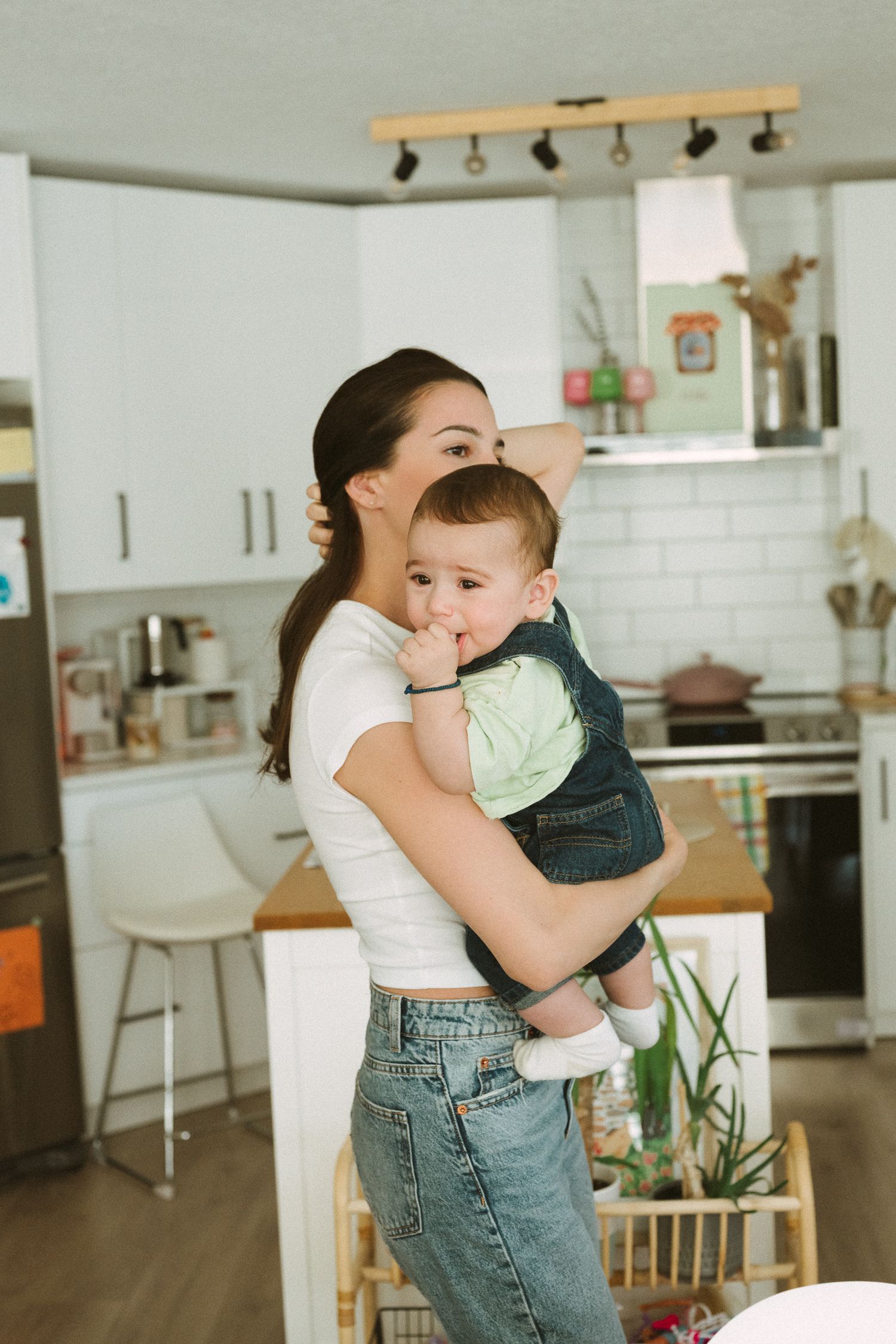 Mother and child sharing tender moments in a bright modern kitchen setting.