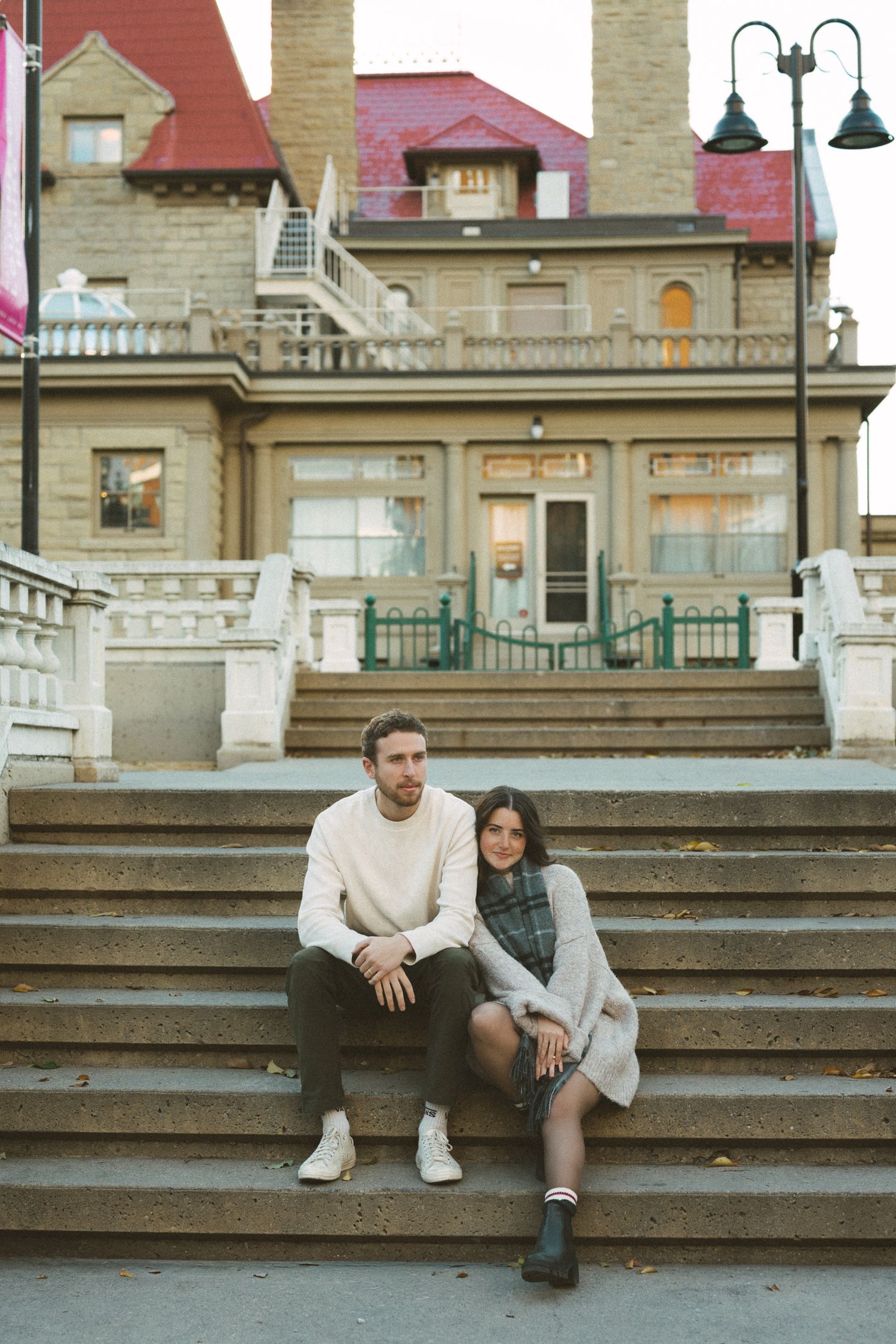 A sequence of photos showing two people sitting together on concrete steps outside a building.