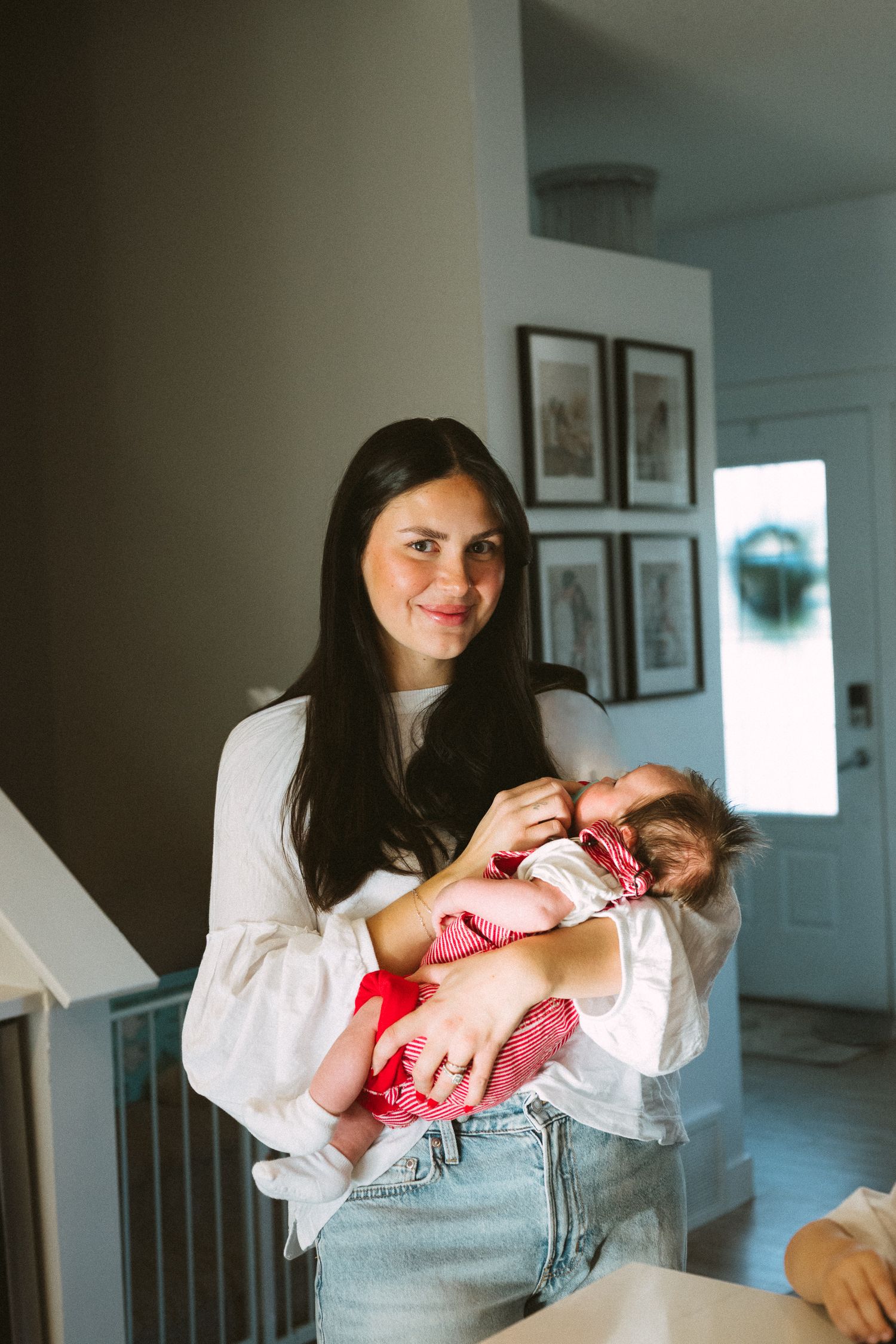 A series of tender moments showing a parent cradling and bonding with a newborn baby in a sunlit room.