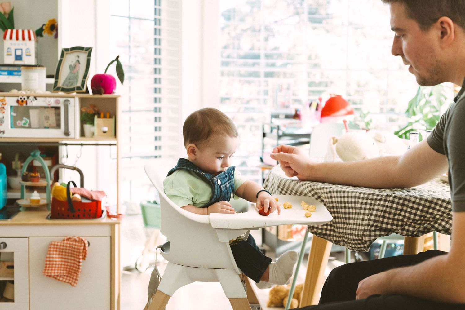Family gathered around a dining table with natural light streaming through windows.
