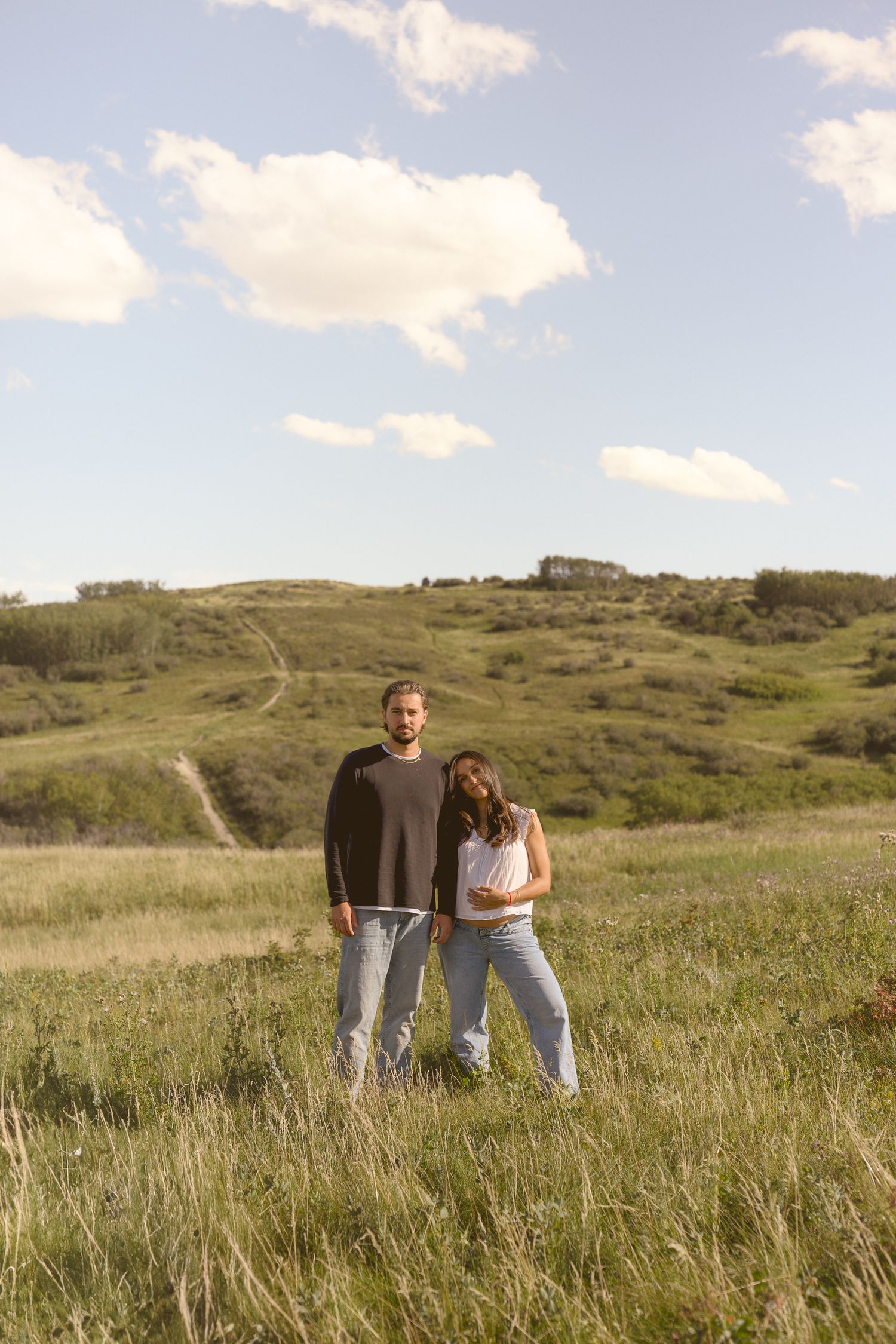 Family enjoying a peaceful moment together in a grassy meadow.