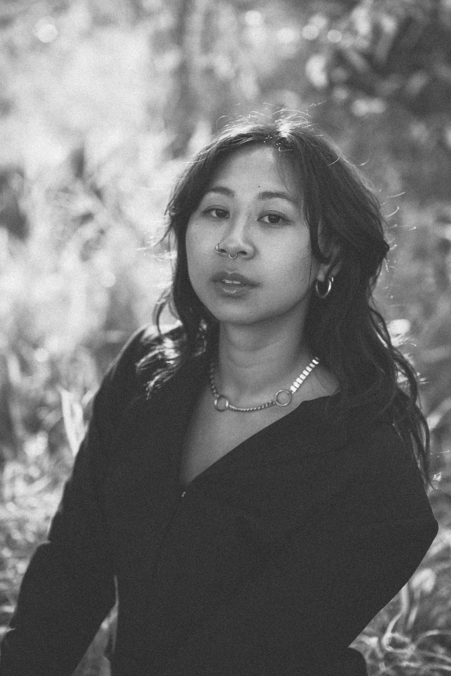 A black and white portrait shot showing dramatic lighting and shadows.