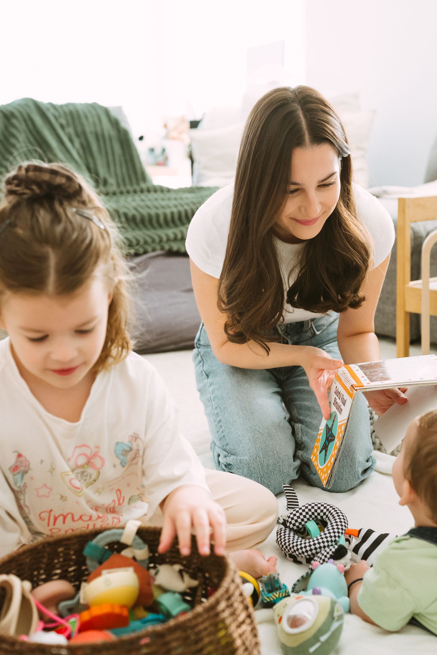 Children playing with colorful toys and crafts at a table during creative playtime.