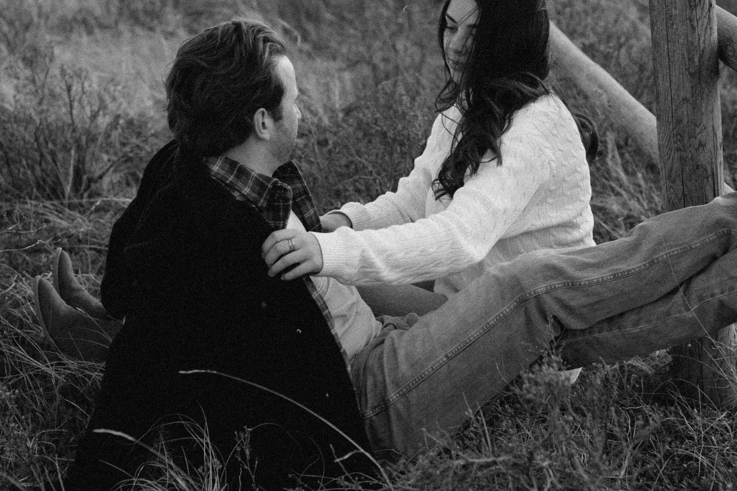 A romantic black and white photo series showing a couple embracing and dancing in a natural outdoor setting.