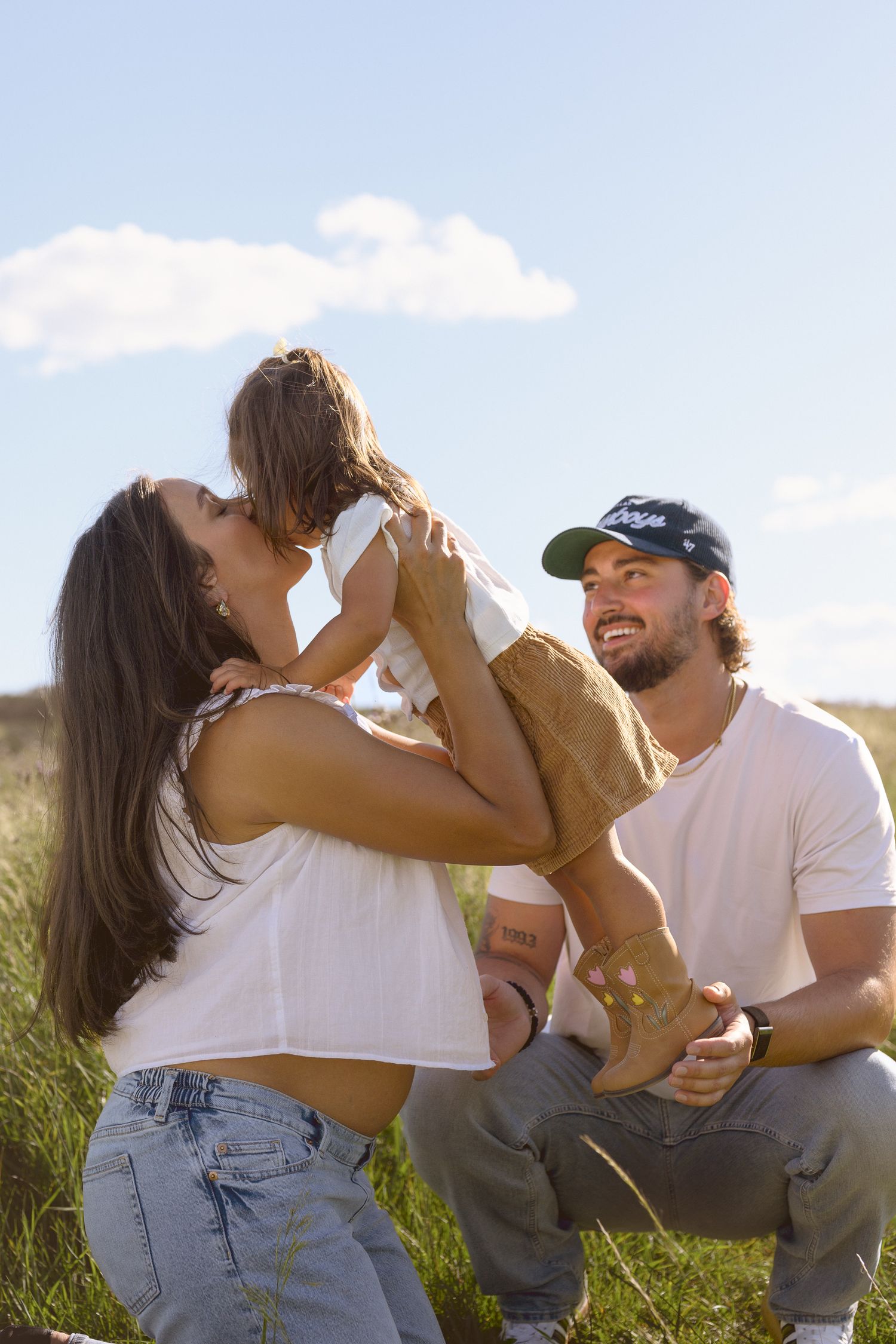 Happy moments shared between people in a sunlit grassy field.
