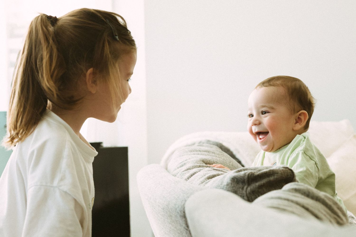A heartwarming interaction between two children showing pure joy and laughter.
