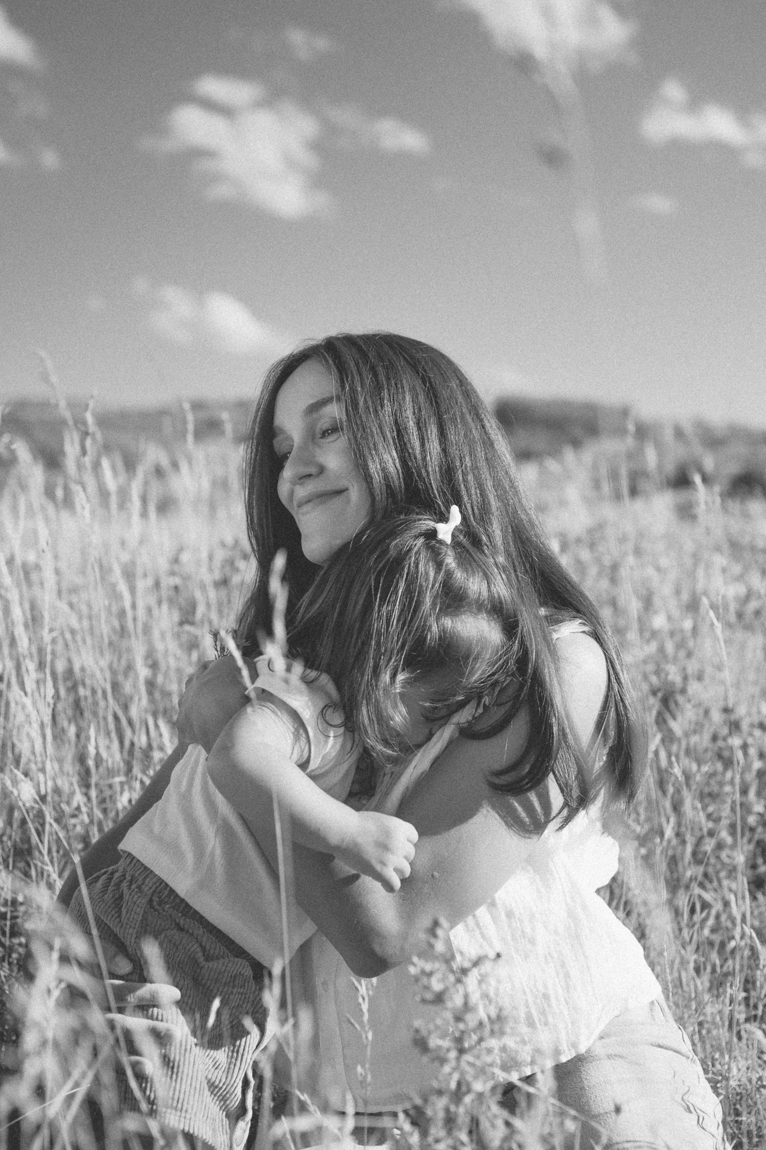 Black and white photo of someone exploring tall grass in a meadow.