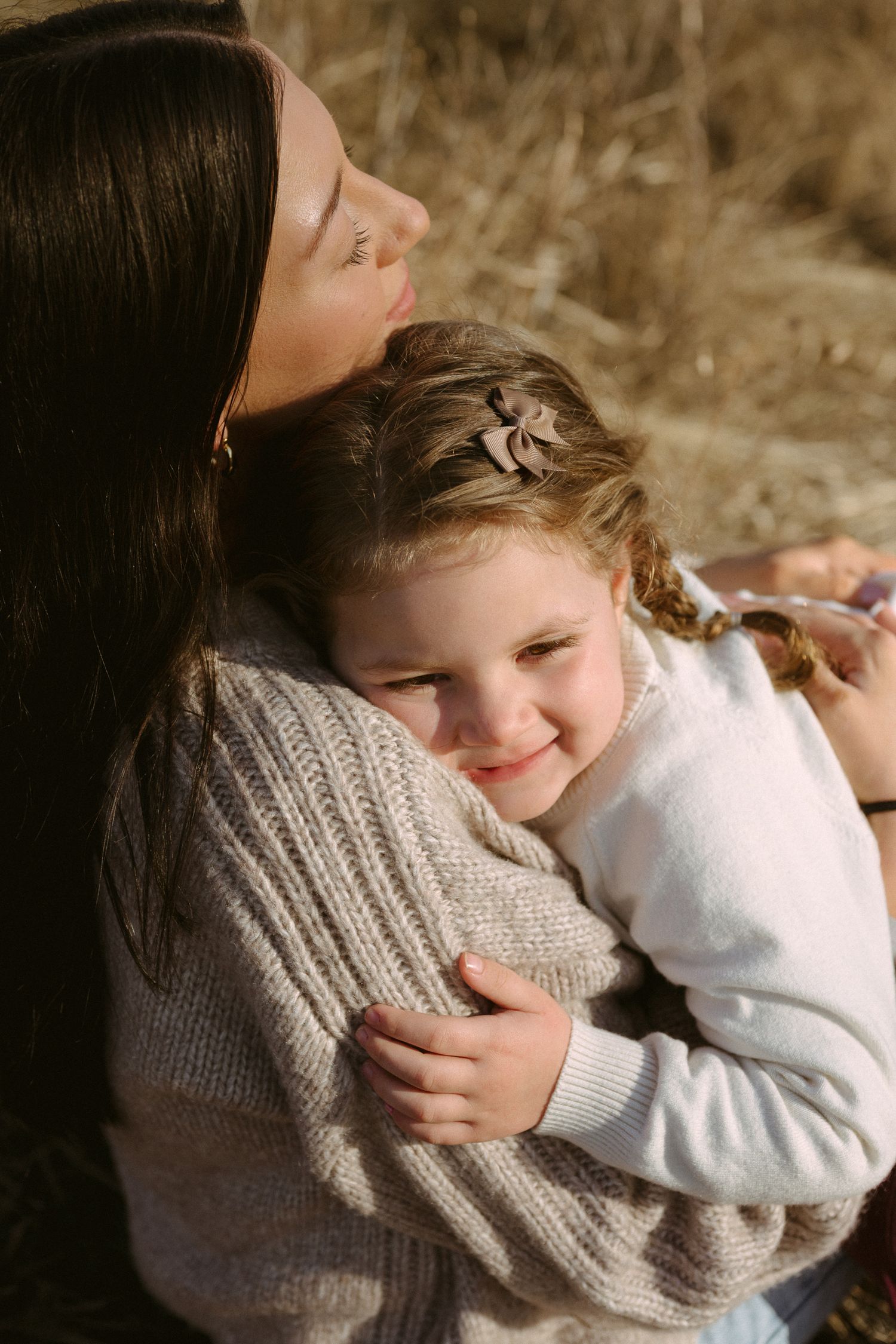Intimate photo series capturing warm embraces and genuine smiles in soft afternoon light.
