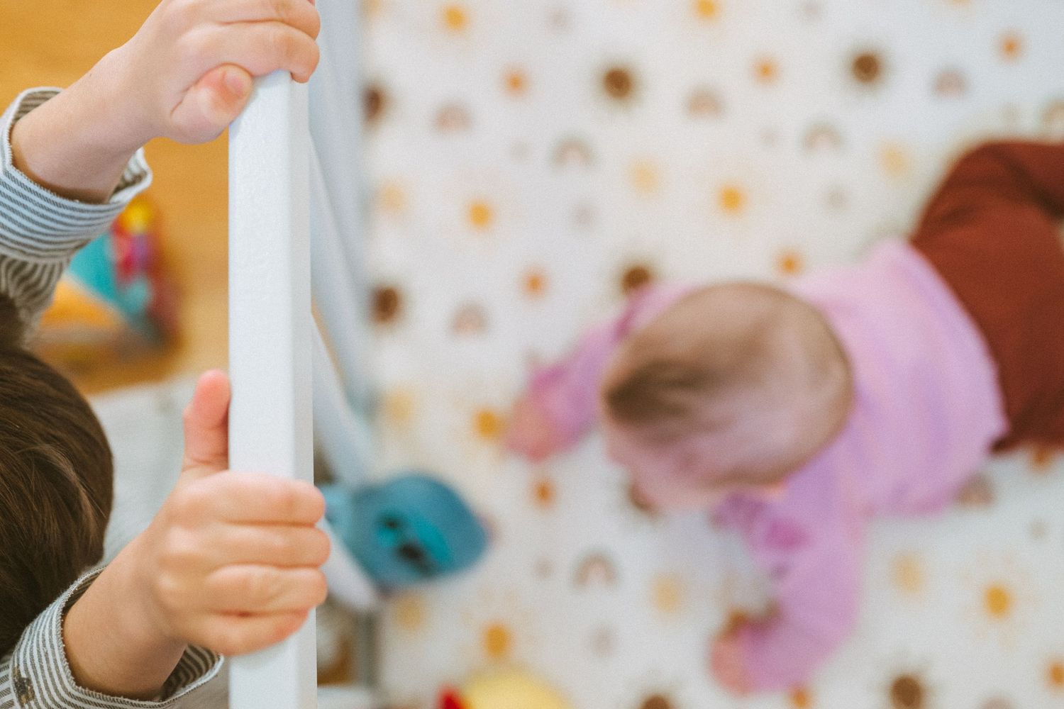 Colorful toys and craft supplies scattered on a wooden floor during playtime.