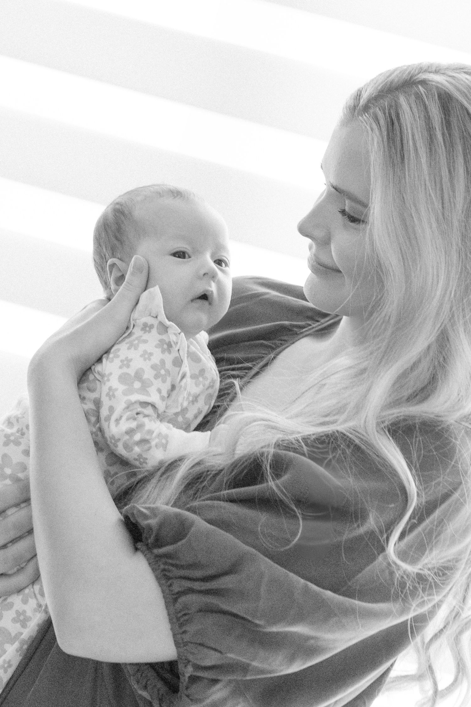 Black and white series of intimate moments between parents and their young baby.