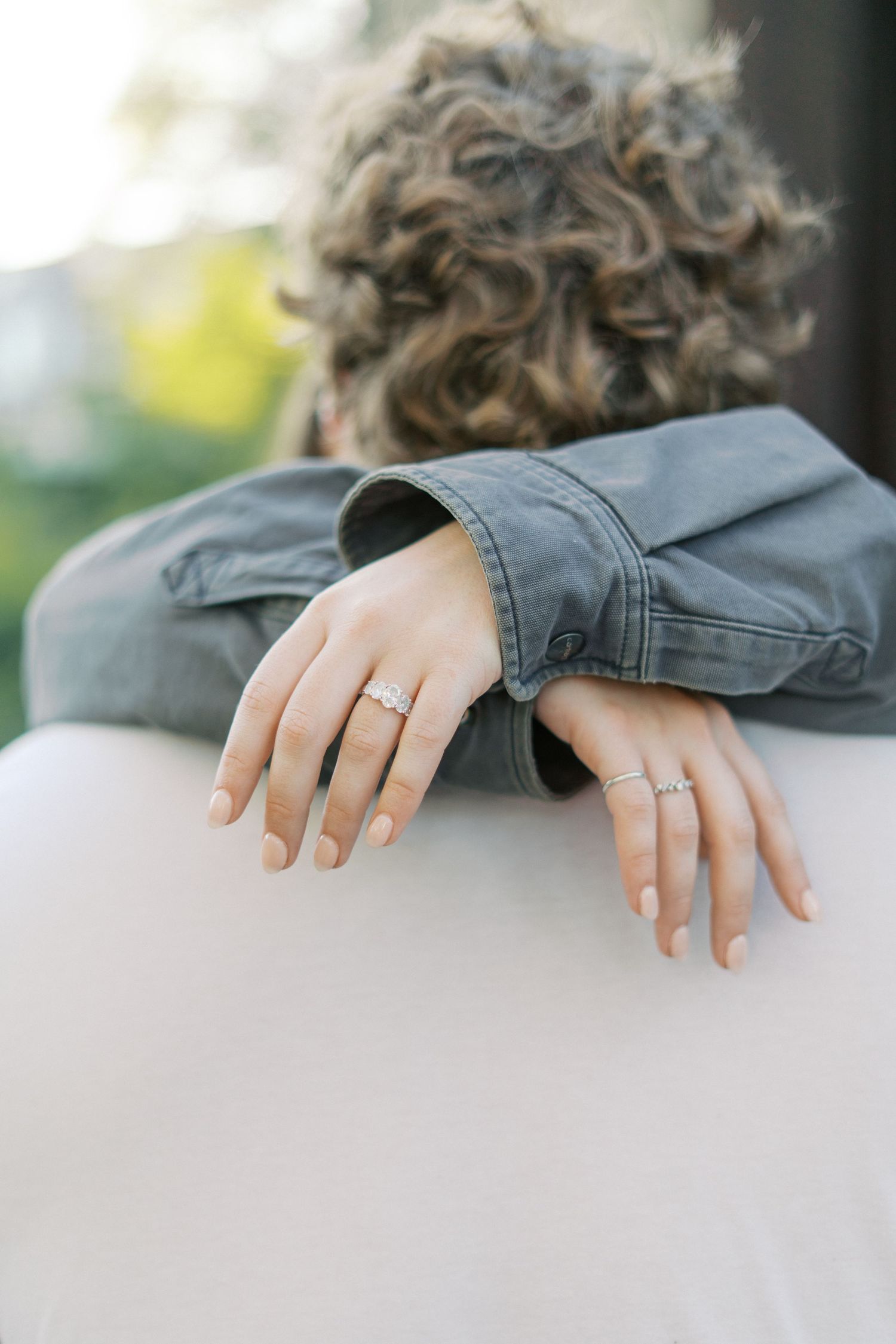 Close-up series showing hands with engagement and wedding rings against a light background.