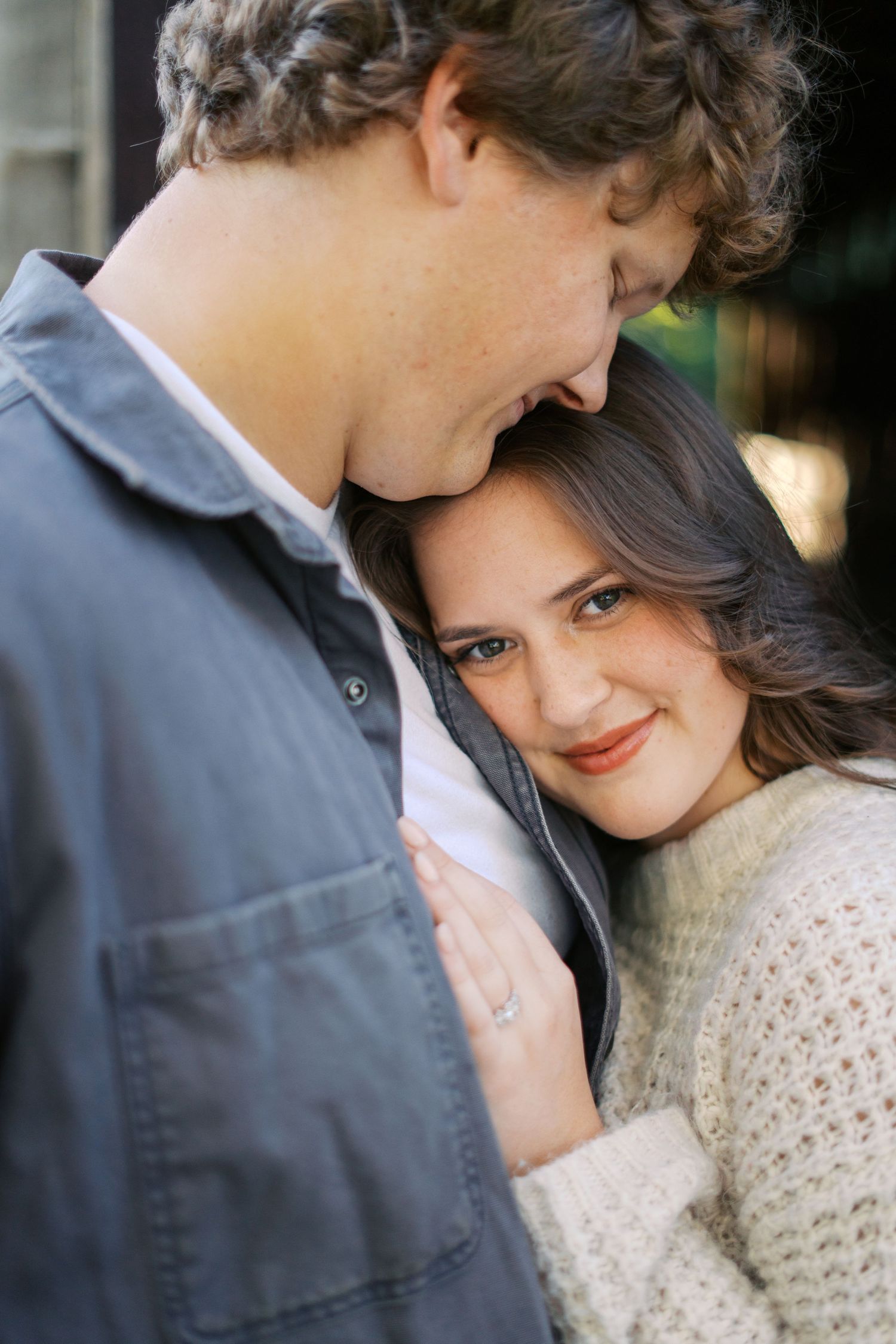 Intimate portrait of couple in casual attire sharing tender moments.