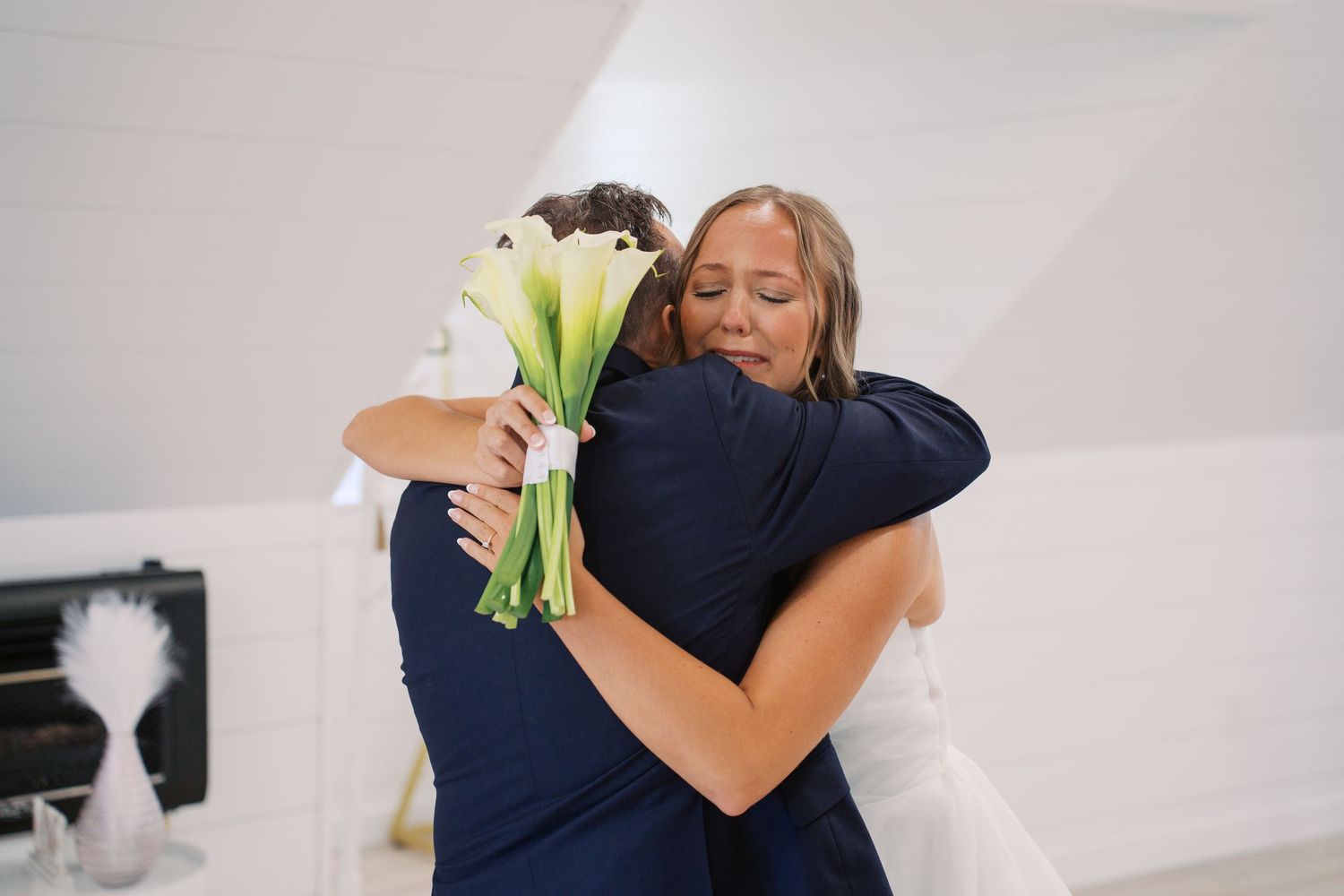 People share emotional embraces during a wedding celebration.