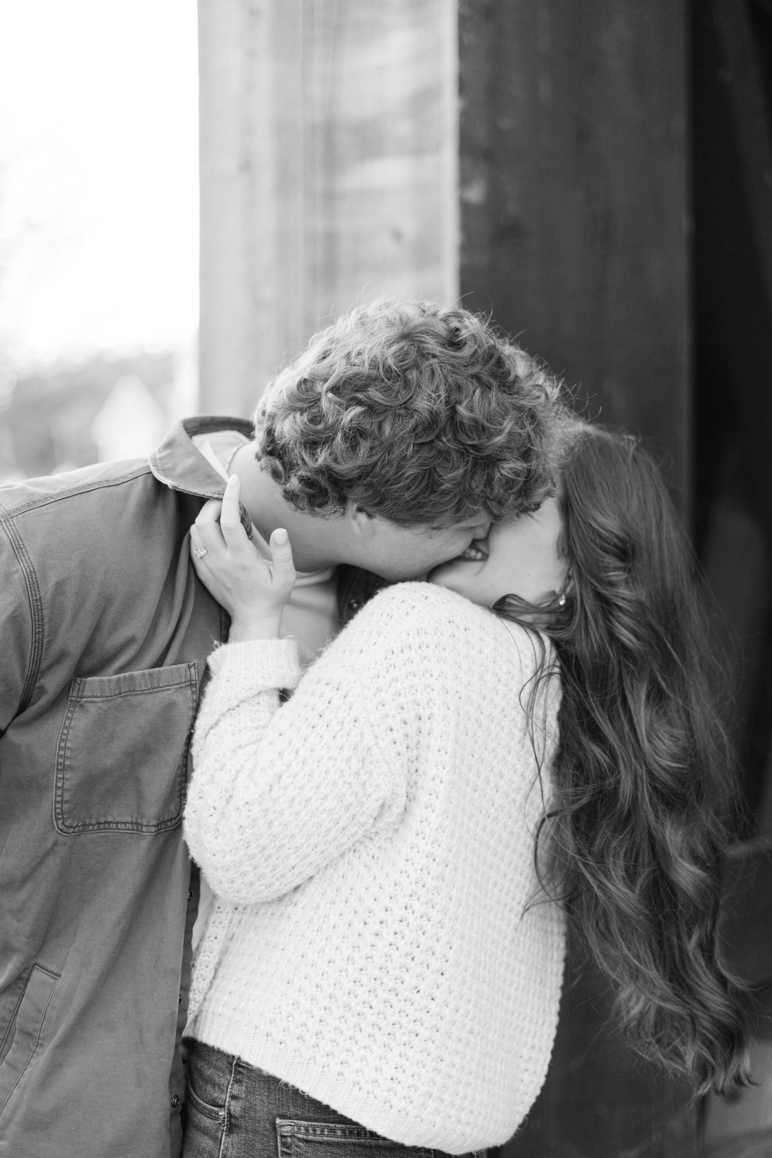 Close-up romantic moment captured in black and white tones.