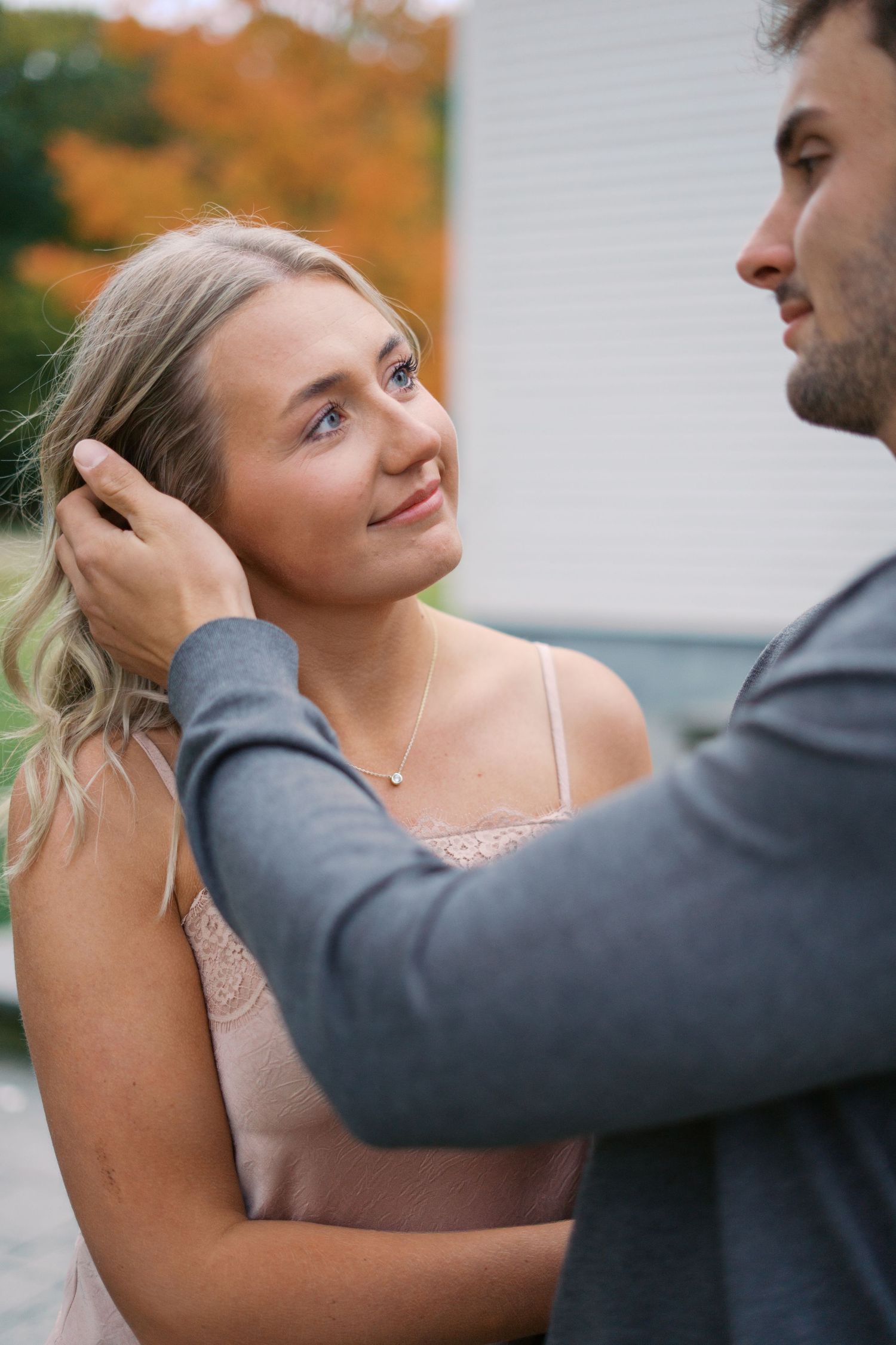 Tender embrace shared between a couple during an autumn photoshoot.