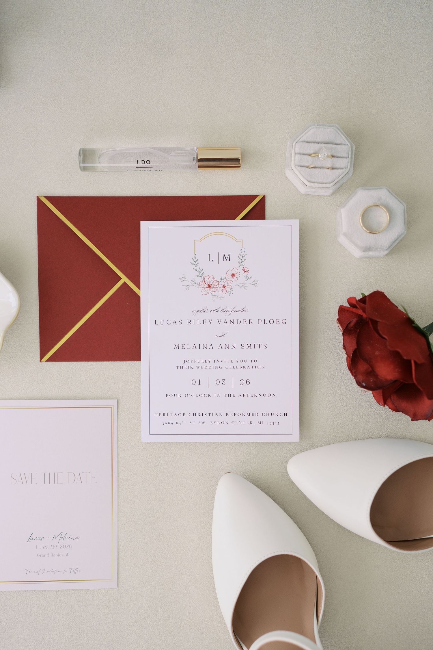 Elegant wedding invitation suite in burgundy and blush pink with gold accents and floral details.