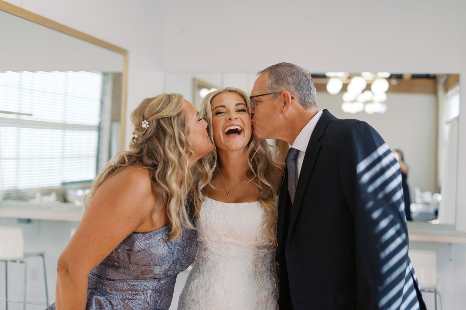 Emotional wedding day moments captured with family in an indoor setting.