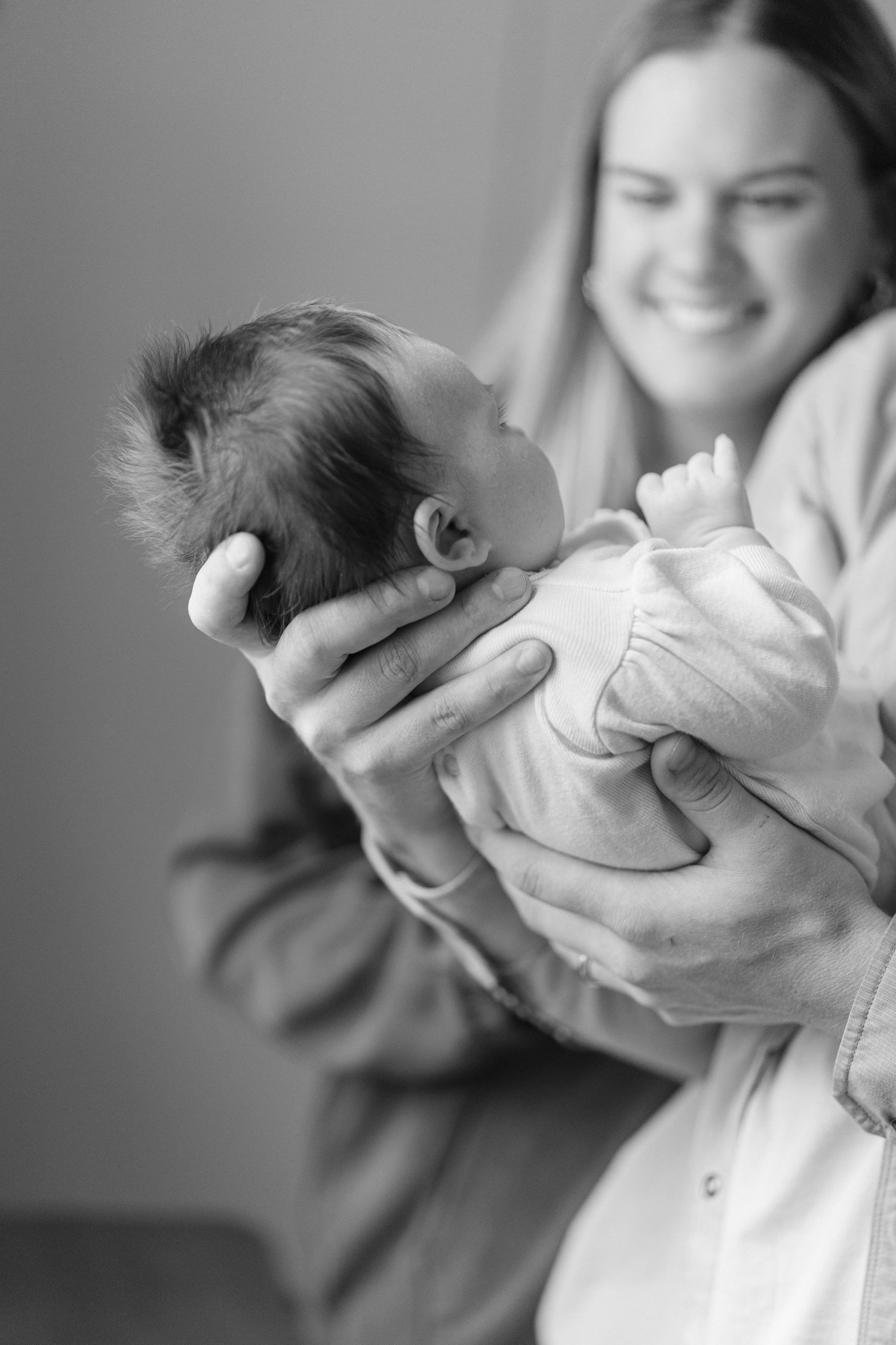 Black and white series showing gentle moments with a newborn baby.