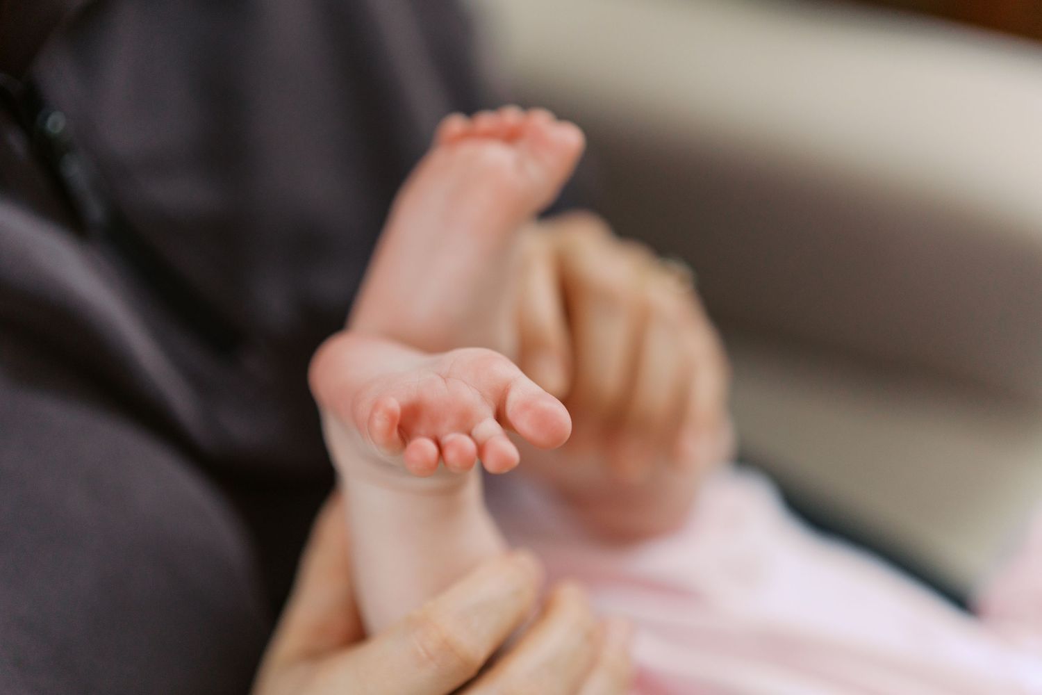 Close-up of baby's feet during indoor photo session.