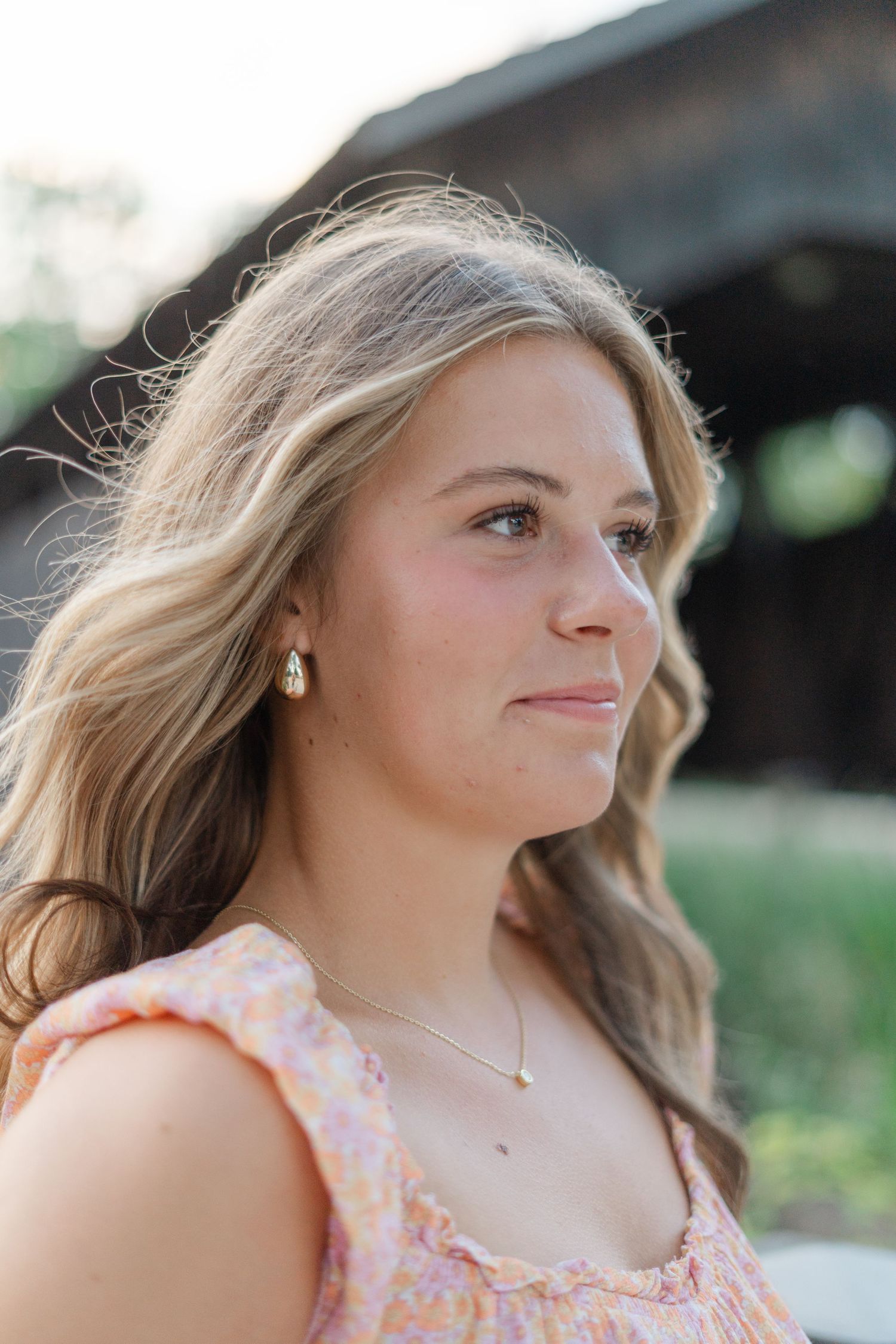 Natural light portraits captured against weathered wood showing soft expressions and blonde hair.