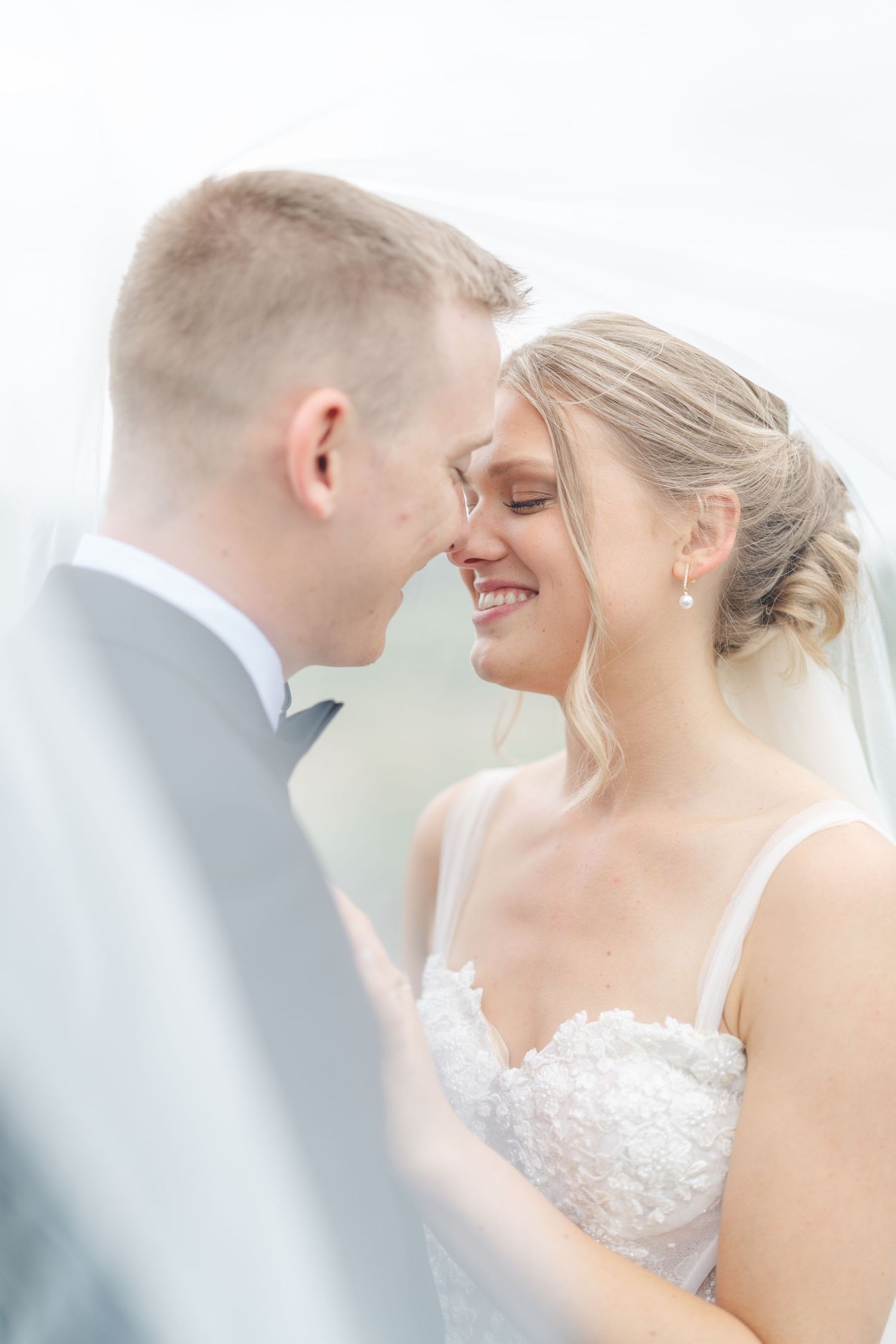 Soft, ethereal wedding portraits capture intimate moments between newlyweds.