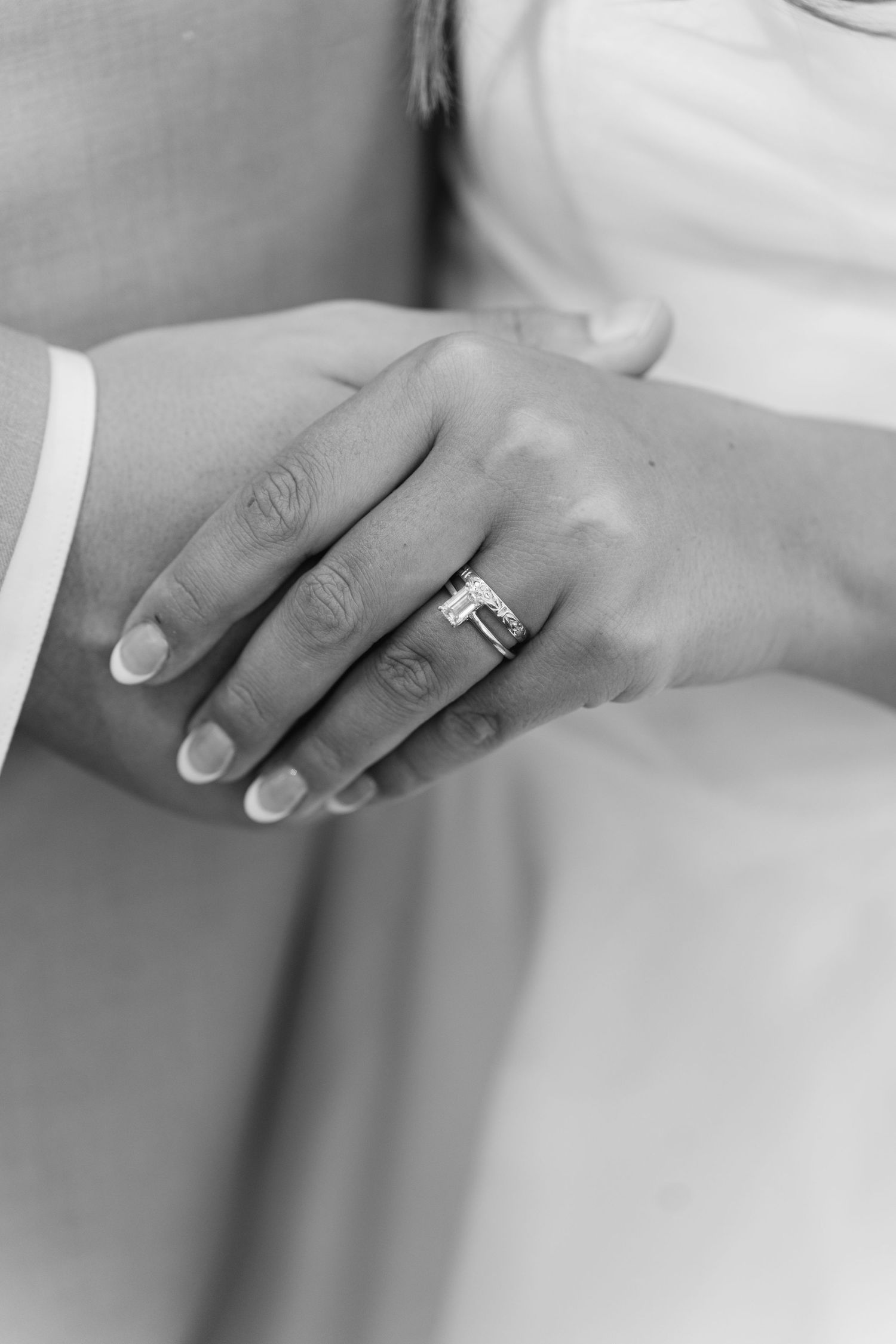 Black and white detail shots of wedding rings and hands.