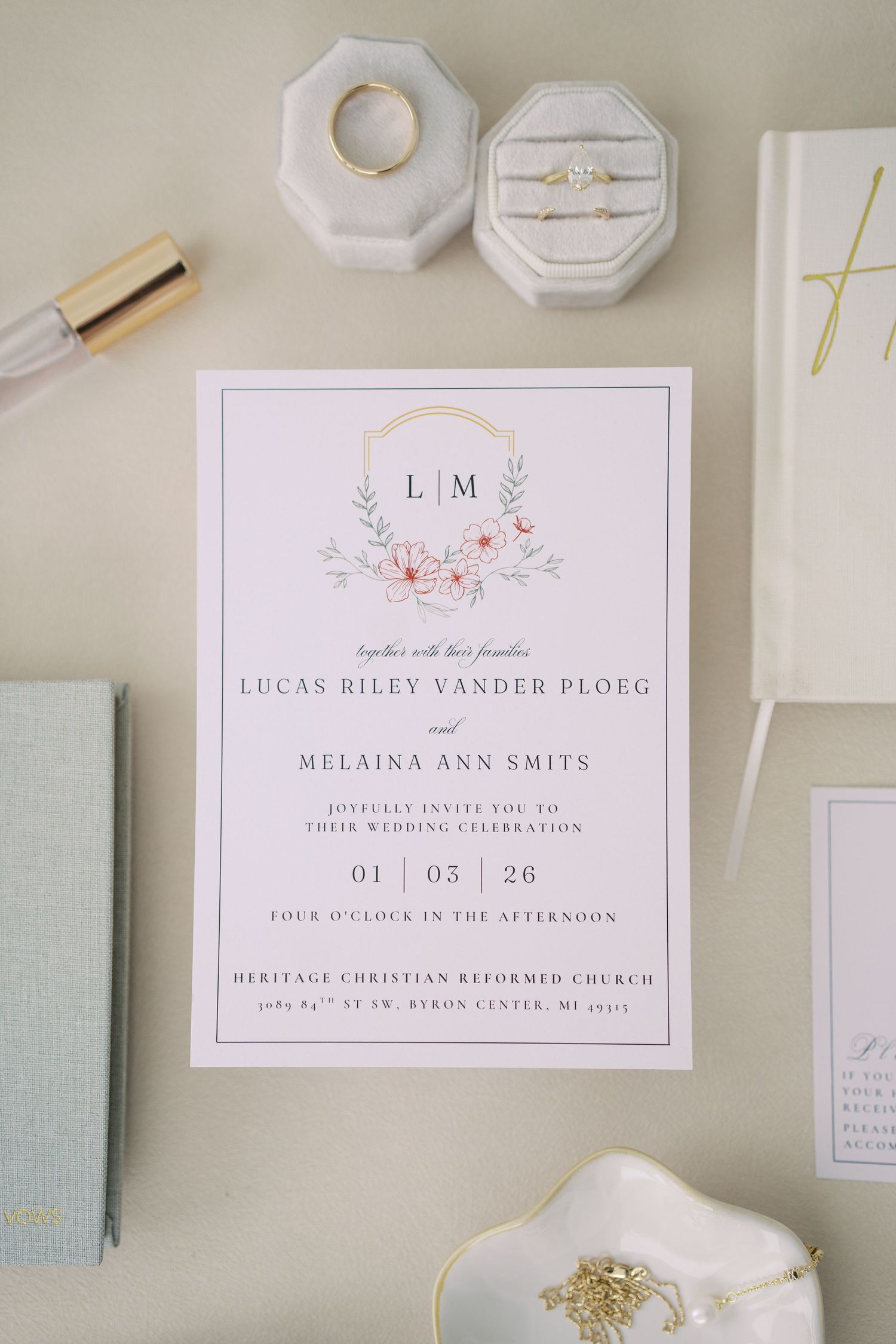Minimalist wedding invitation suite in white and mint green with floral accents.