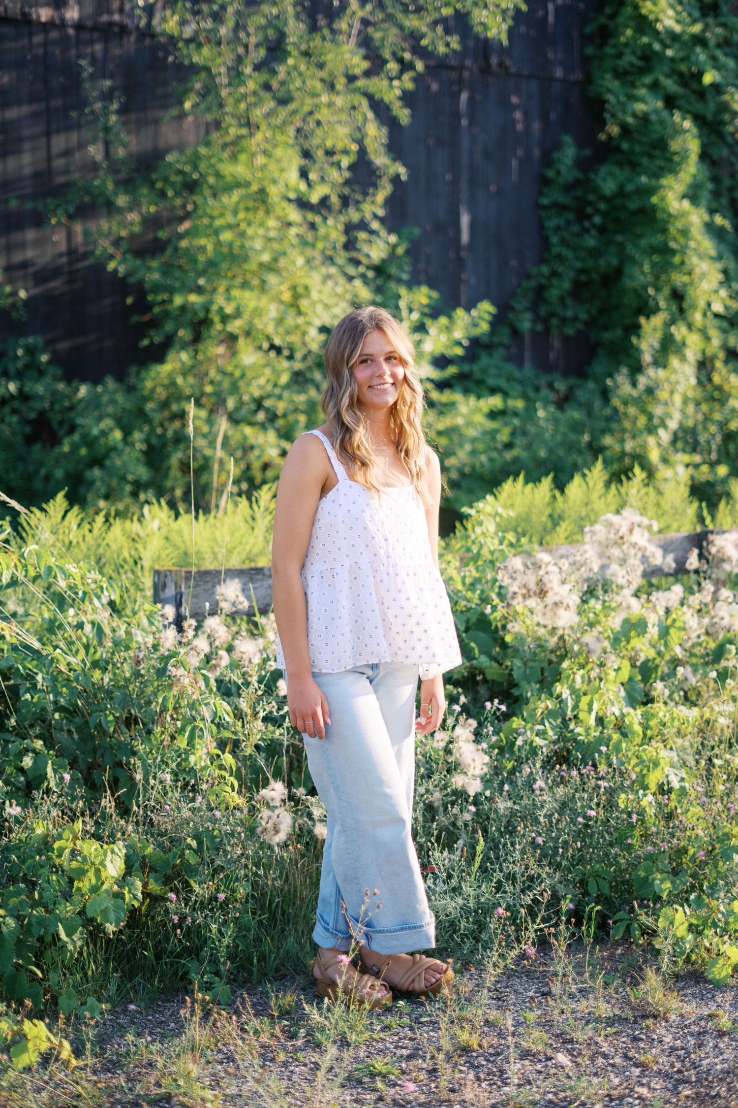 Candid outdoor photography session amid blooming flowers and natural scenery.