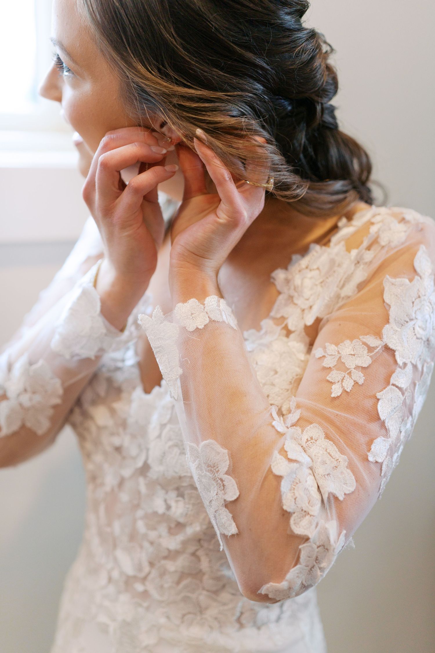 Close-up of intricate lace details on bridal gown shoulder and neckline.