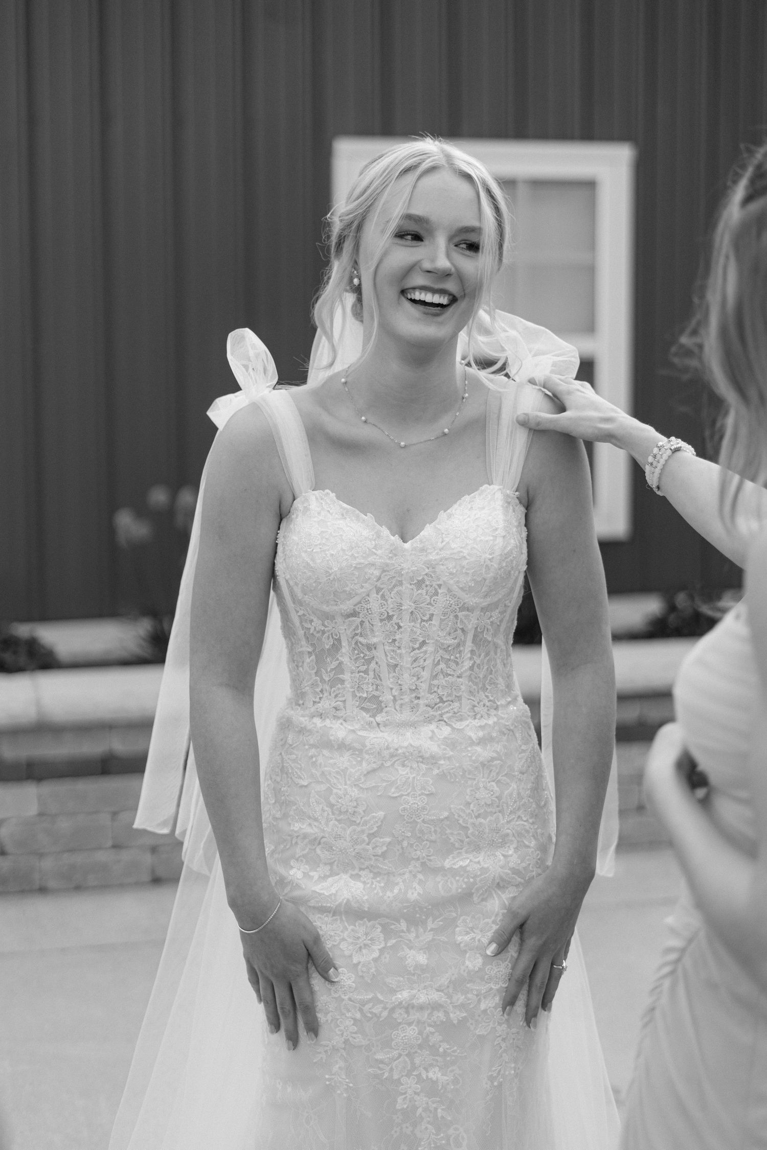 A sequined white wedding gown sparkles in black and white photography.
