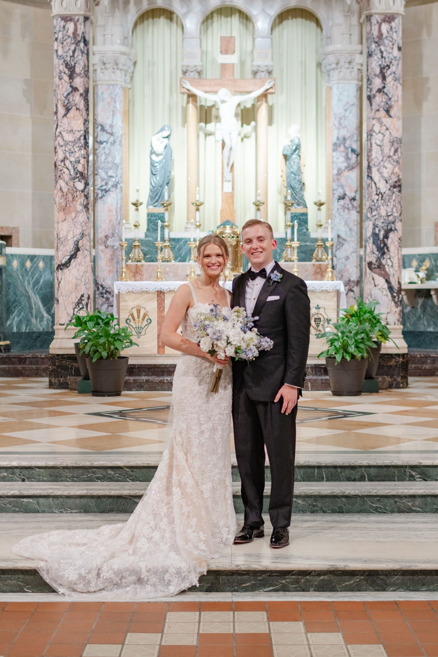 Wedding portraits taken in an ornate church interior with marble columns and elegant architectural details.