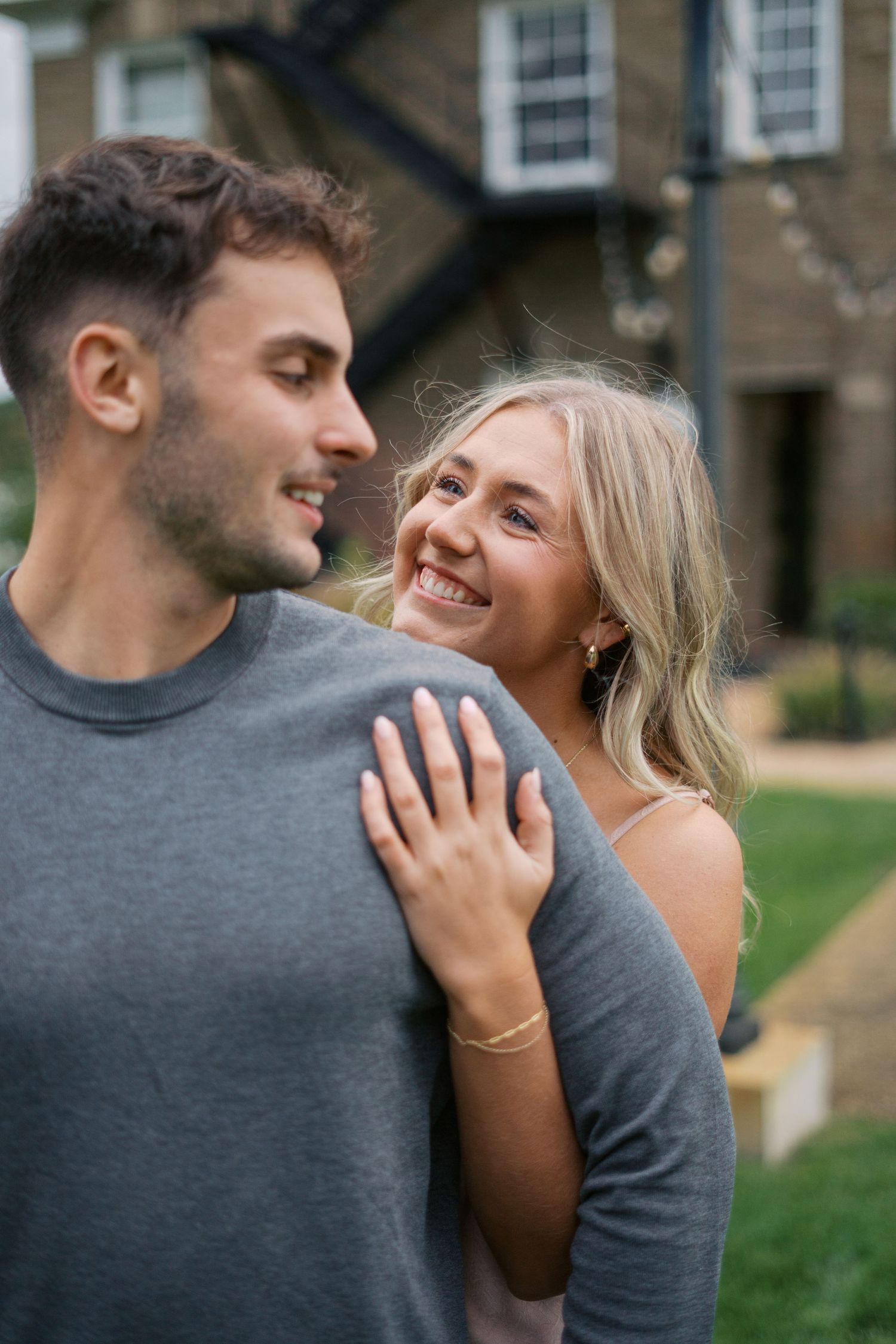 A sweet candid moment between a couple outdoors with natural lighting.