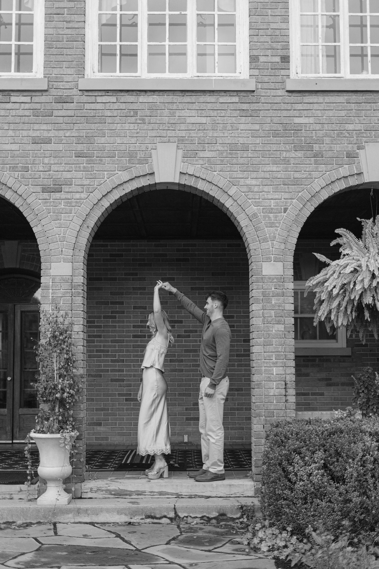A sequence of photos showing a surprise proposal under brick archways.