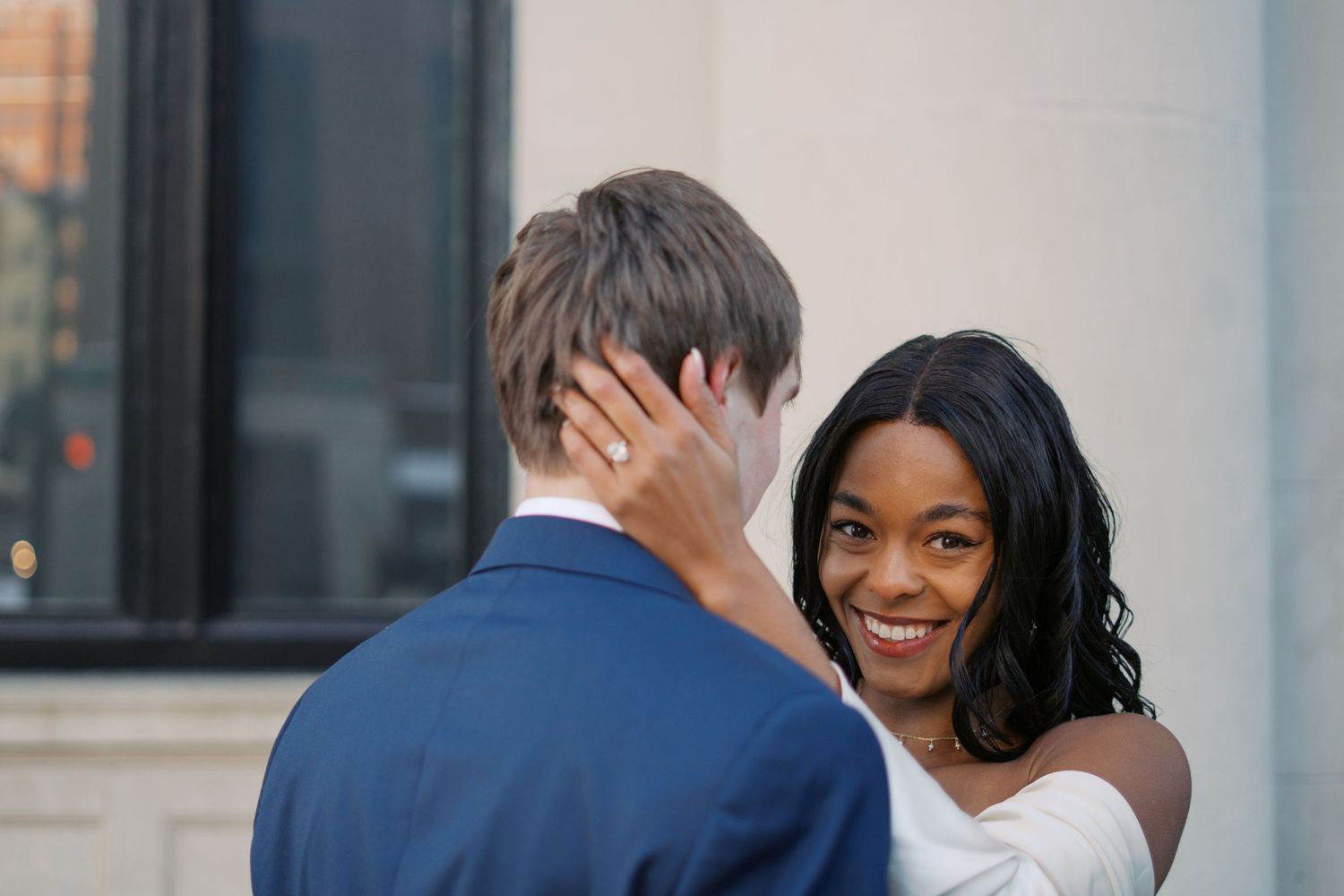 A couple shares laughter and joy during their wedding photoshoot.