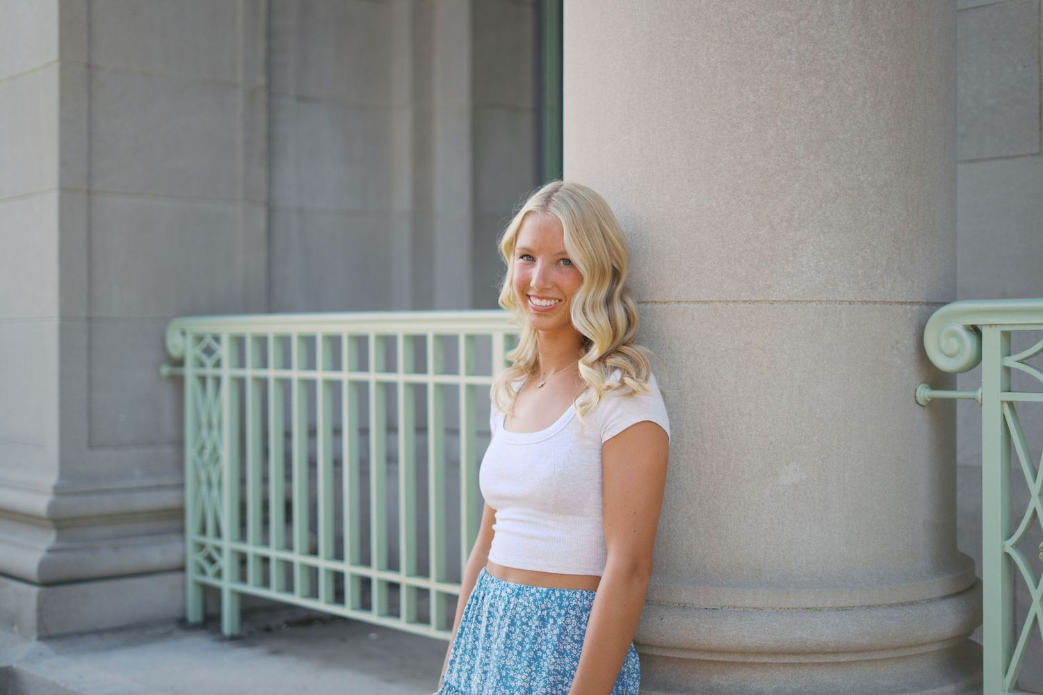 Architectural portraits against white columns featuring casual summer attire.