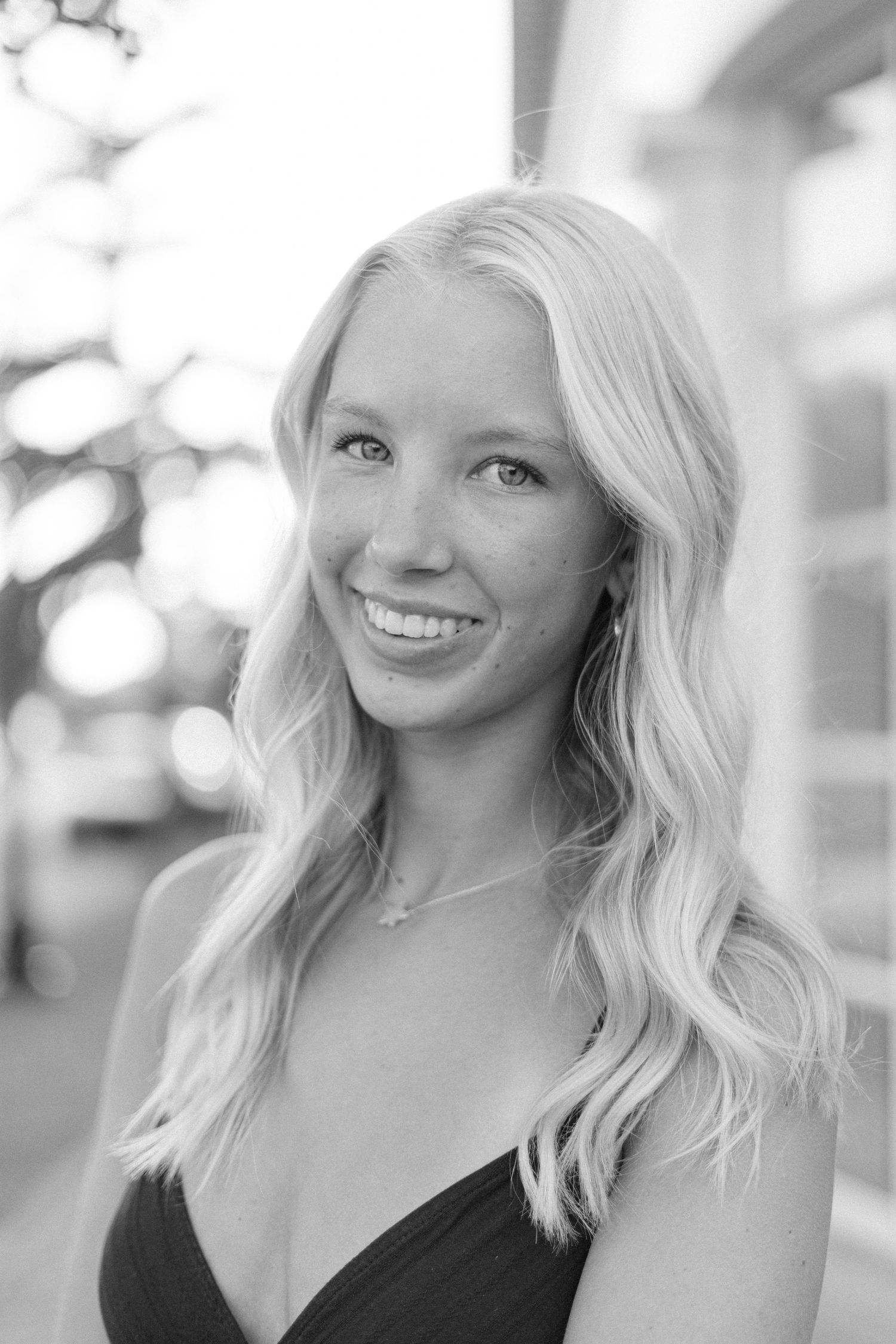 Black and white portrait series showing joyful expressions and wavy blonde hair.