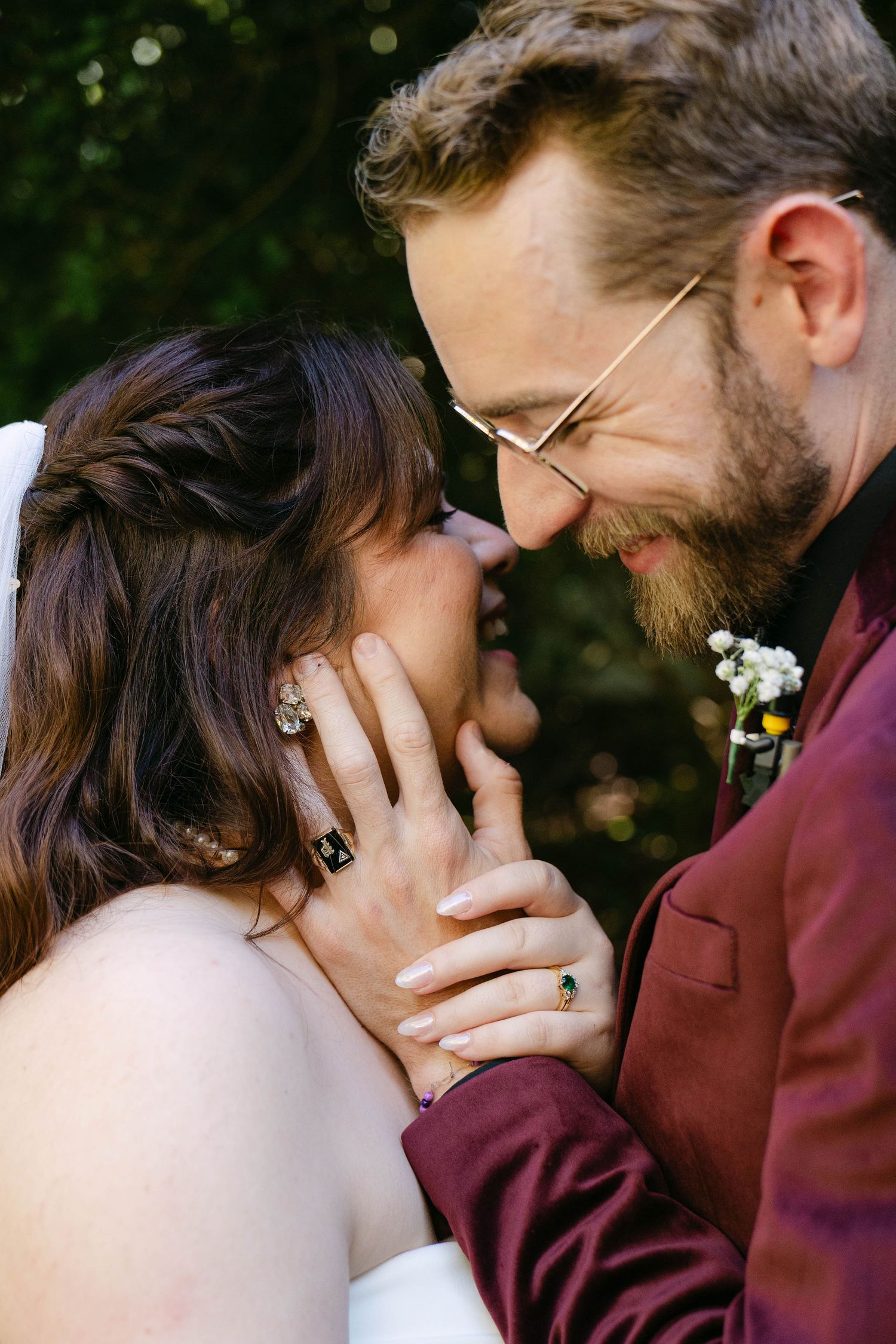 A romantic sequence of intimate moments between a couple in burgundy and white wedding attire against a natural backdrop.