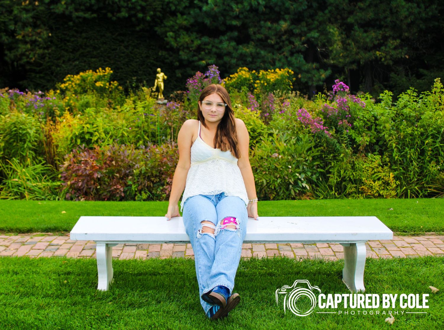 This is a picture of a girl sitting on a bench
